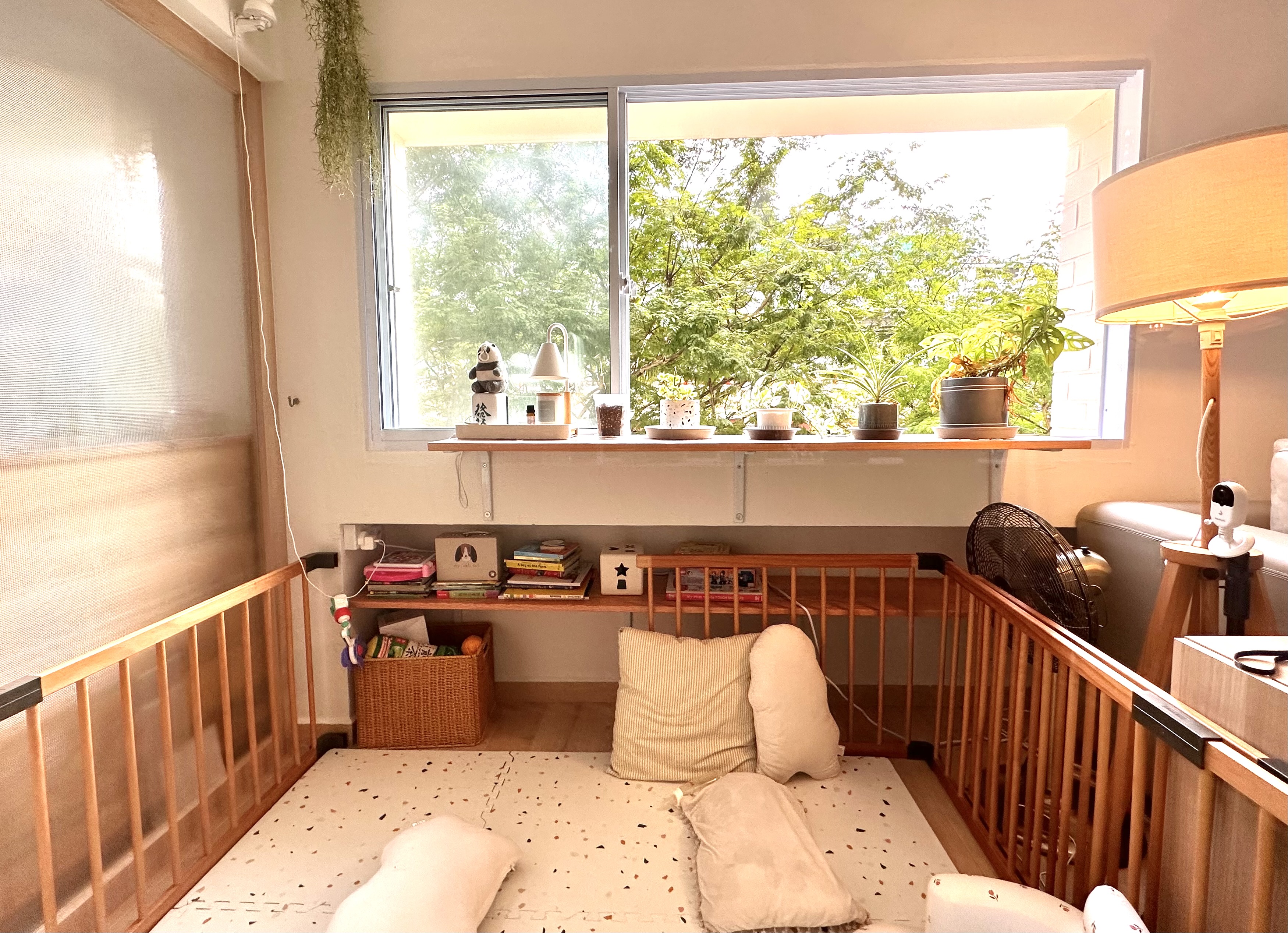 Reconfiguring the space for my toddler - Wooden crib, baby pillow, white blanket, wooden railing, baby gate, potted plants