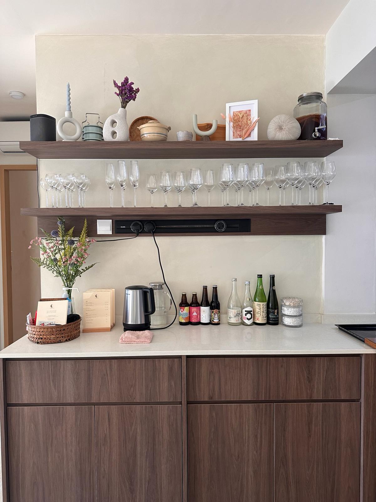 Wabi-Sabi home designed by Chefs to host Private Dinners - wine glasses, wine bottles, Japanese sake, wooden shelves, elegant