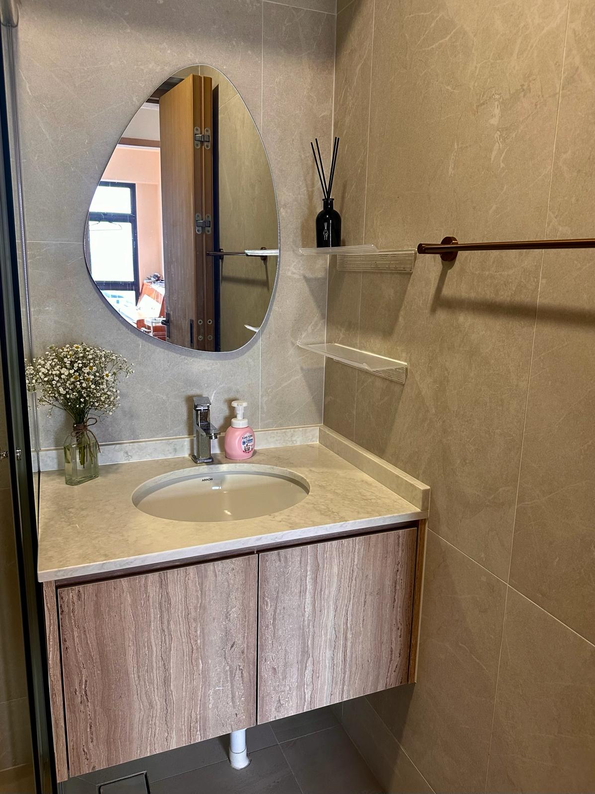 Wabi-Sabi home designed by Chefs to host Private Dinners - Round mirror, marble countertop, wooden cabinet, white sink, pink