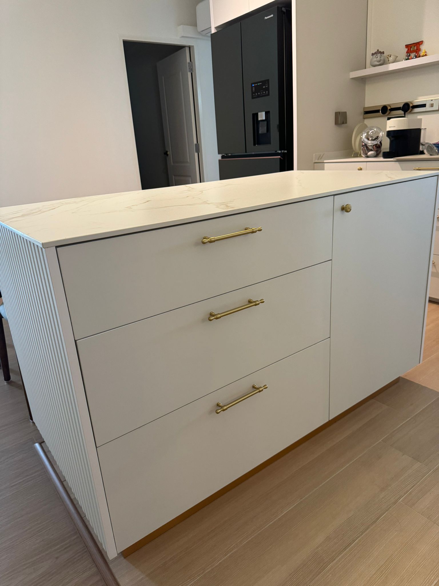 Dining Space: Modern luxury marble dining table connect with island - White kitchen island with gold handles, modern kitchen