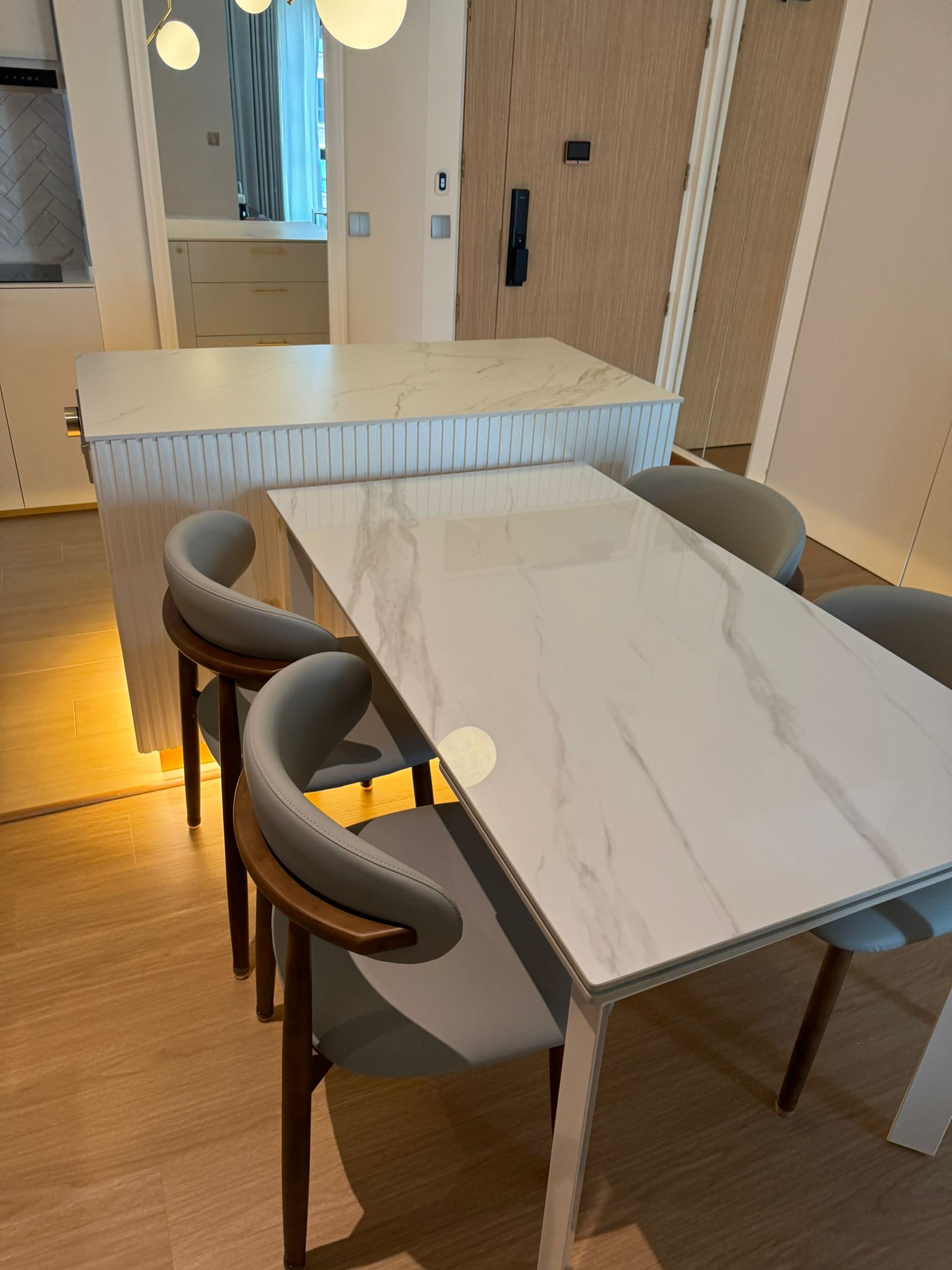Dining-Space:-Modern-luxury-marble-dining-table-connect-with-island