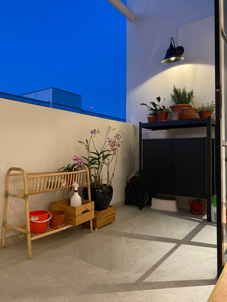 A Modern Farmhouse - vibrant orchids, indoor garden, cozy corner, modern decor, hanging lamp, white bucket, black cabinet