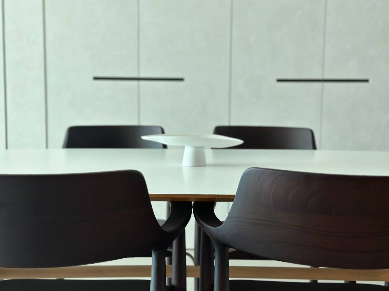 Dining Space with Minimalist Embrace - Modern minimalist dining room, sleek black chairs, white table, contemporary design