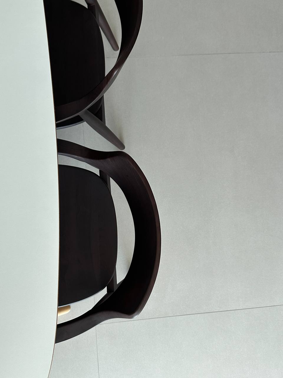 Dining Space with Minimalist Embrace - modern chair, sleek design, dark wood finish, curved backrest, minimalist furniture