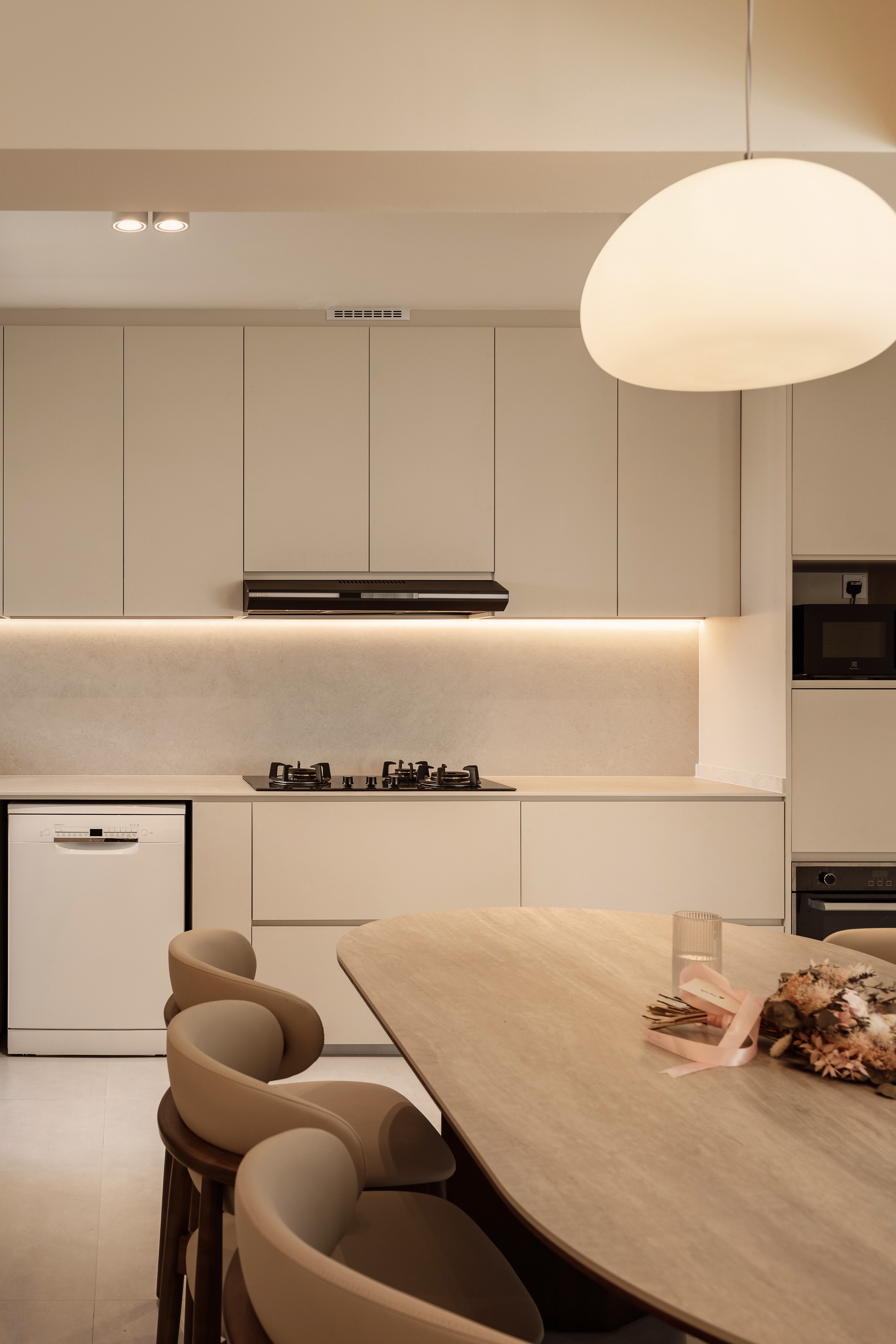 A Creamy Home With Sunrise View  - Modern kitchen with sleek cabinets, minimalist design, beige color scheme, built-in