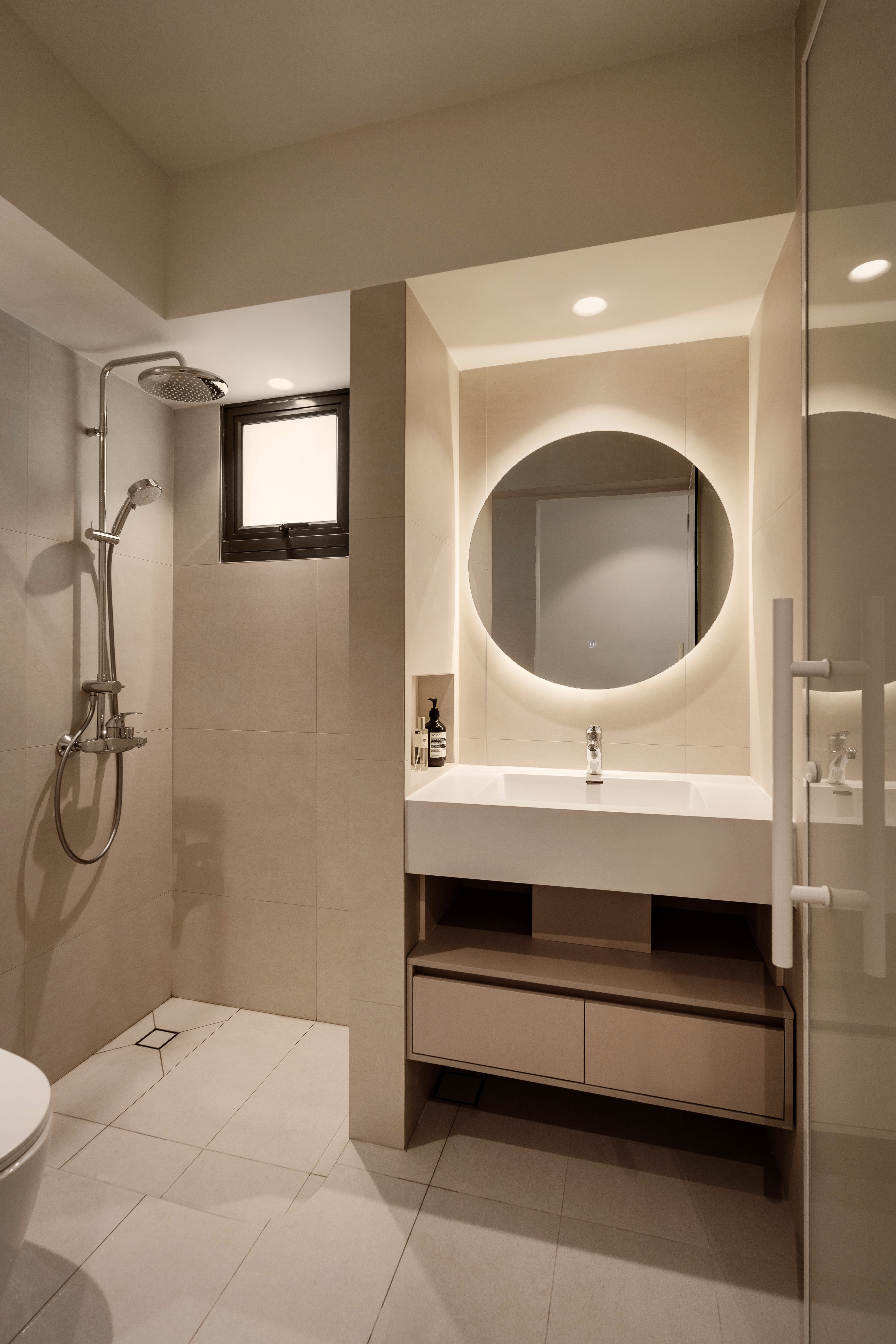 A Creamy Home With Sunrise View  - Modern minimalist bathroom, beige color scheme, sleek fixtures, oval mirror, built-in
