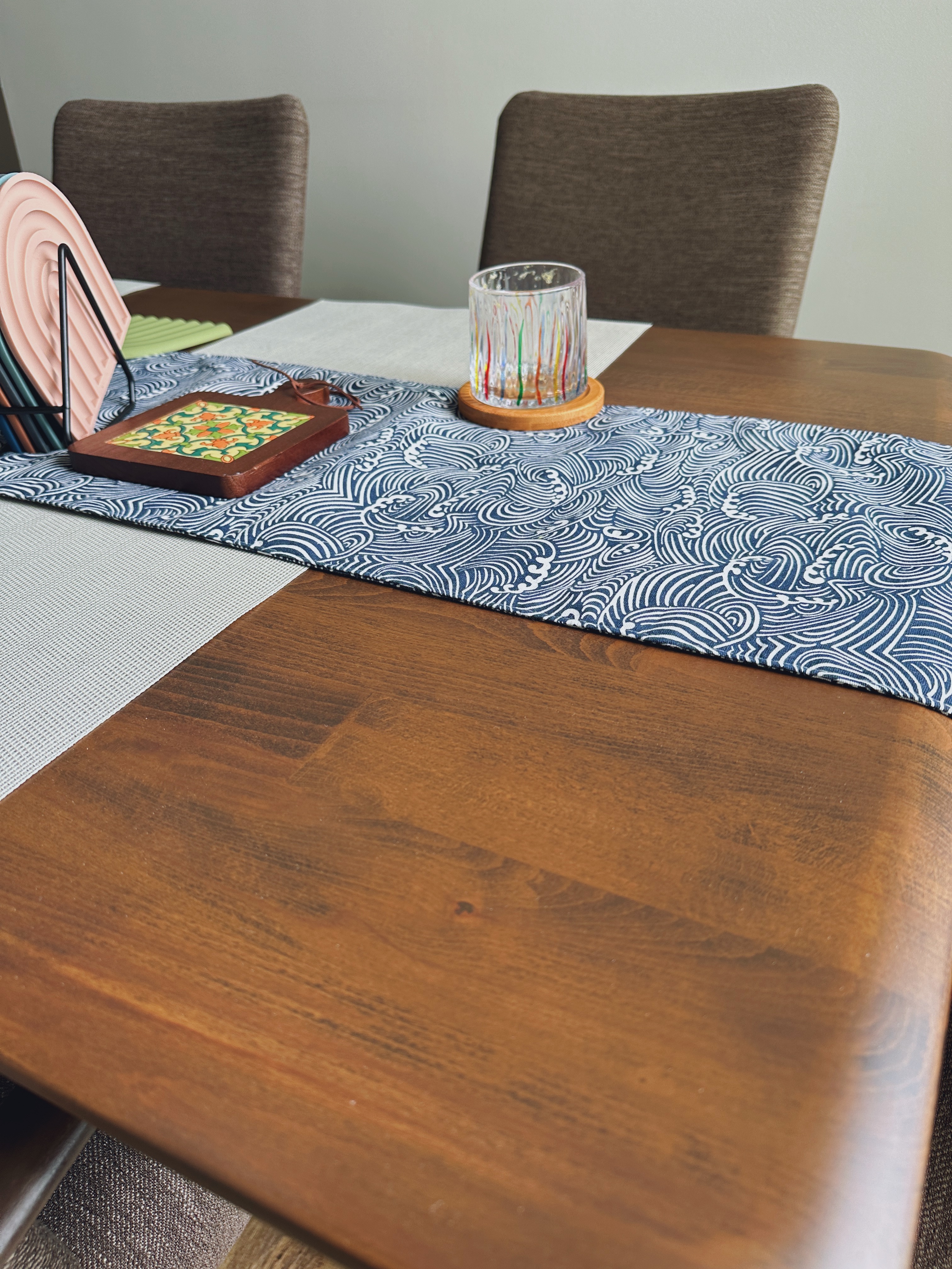 "You can always count on tables to bring people together"  - Patterned placemats, wooden dining table, brown upholstered
