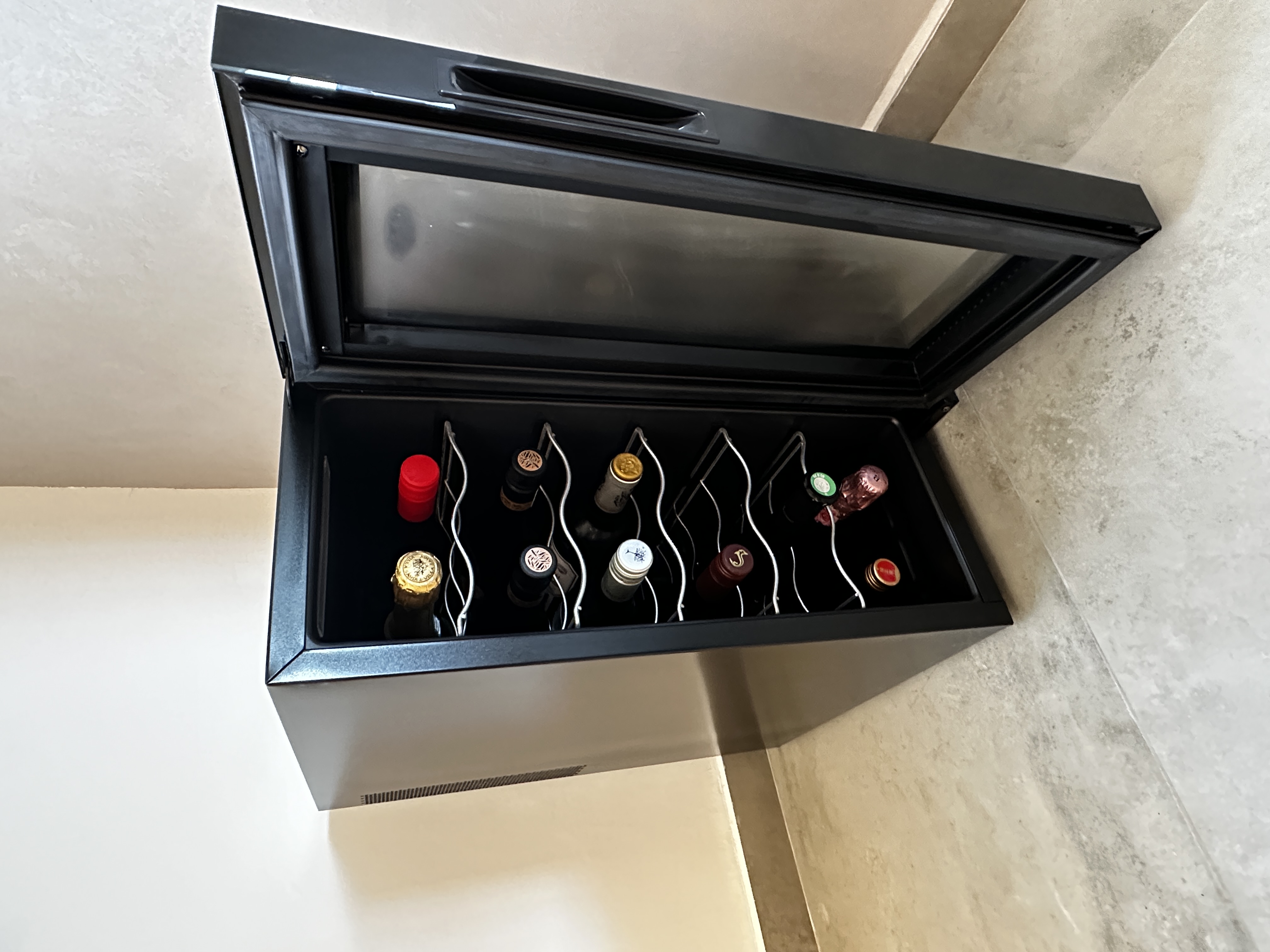 Our Dining Room: Japandi style with raw details - black wine cooler, open wine drawer, neatly organized wine bottles, red