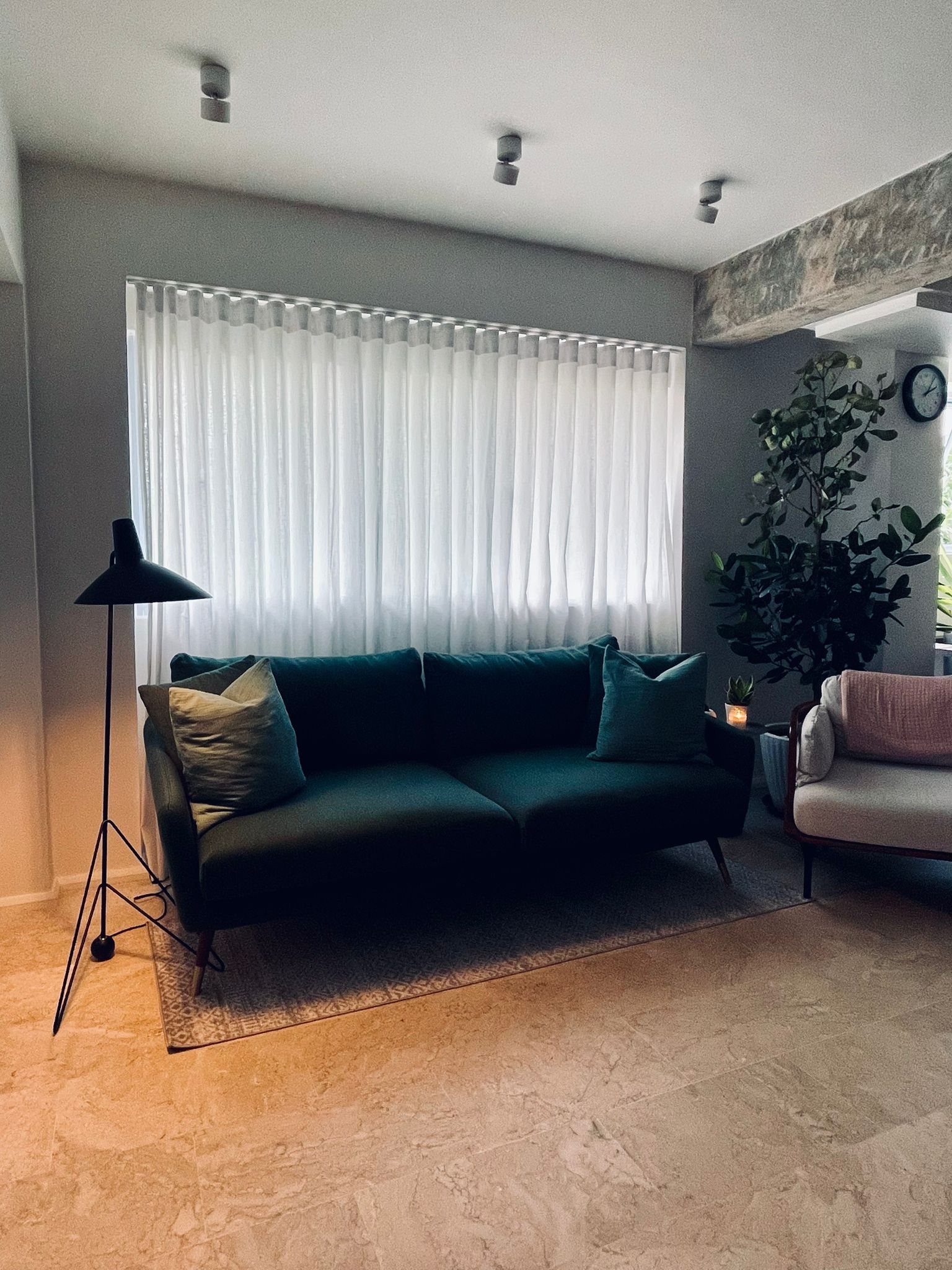 The living room - an intimate space for conversations and more! - Modern living room, cozy seating, dark green sofa, white