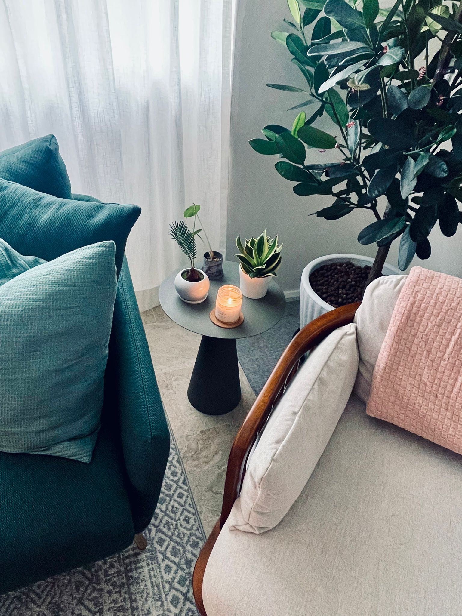 The living room - an intimate space for conversations and more! - Teal sofa, cozy seating, modern decor, soft lighting