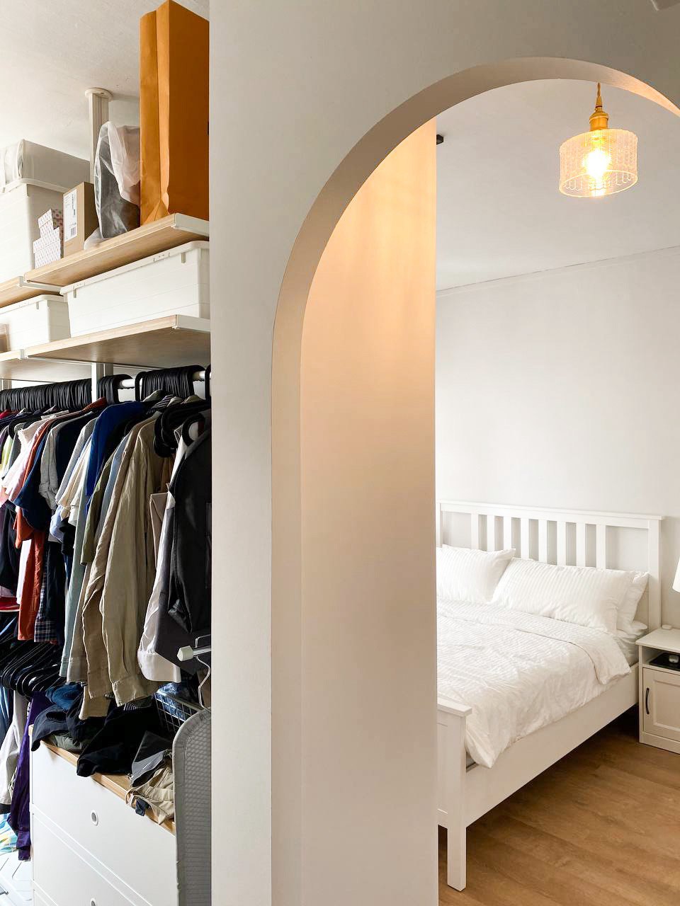 Embrace Serenity: Step into Our Dreamy IKEA-Inspired Bedroom Sanctuary - Organized closet with neatly hung clothes, white bed