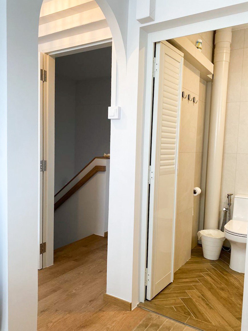 Embrace Serenity: Step into Our Dreamy IKEA-Inspired Bedroom Sanctuary - Bathroom with wooden flooring, white walls, archway