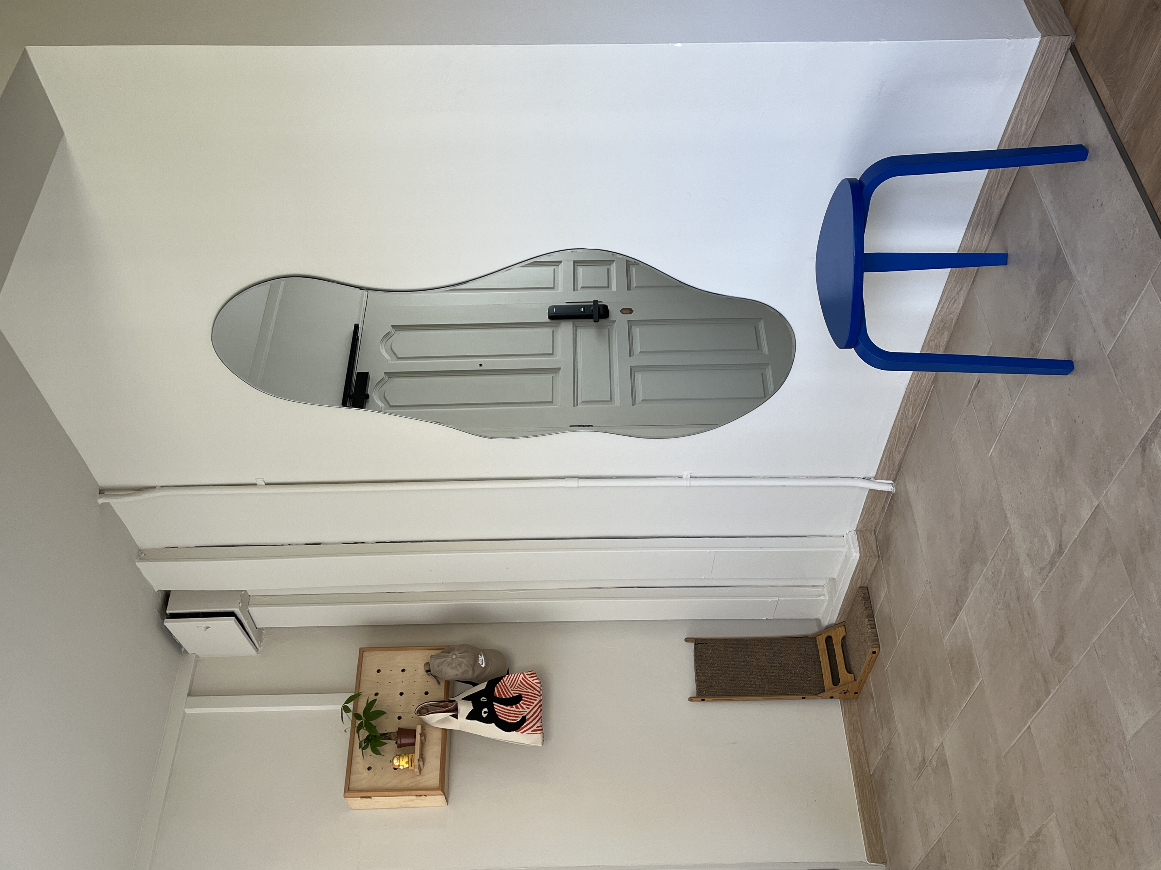 Entryway - Clean & Simple - modern minimalist interior, white walls, geometric design, open door, blue chair, wooden shelf