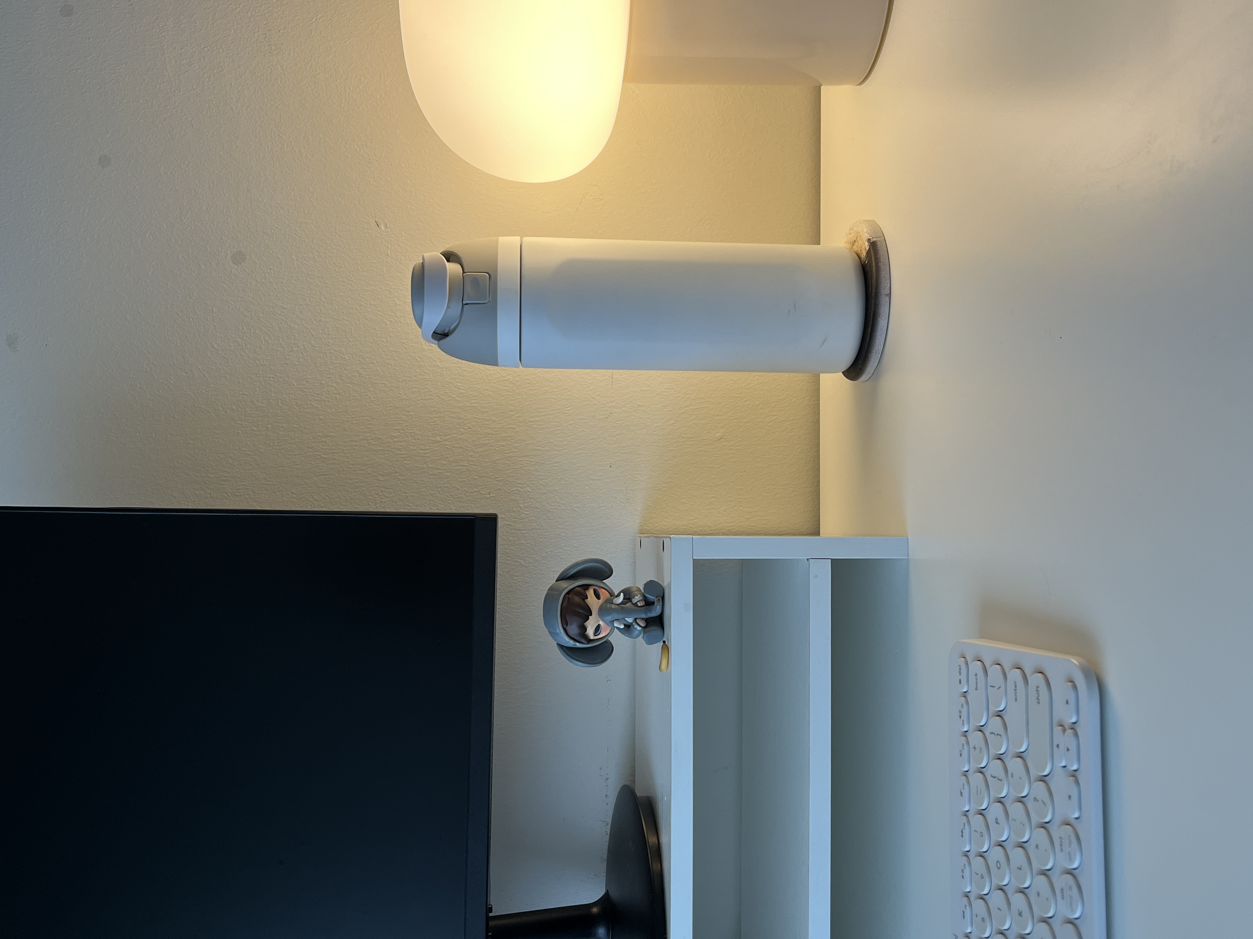 Multi-Functional Space: The Workspace Guest Room - White wall-mounted keyboard, minimalist design, modern aesthetic, sleek