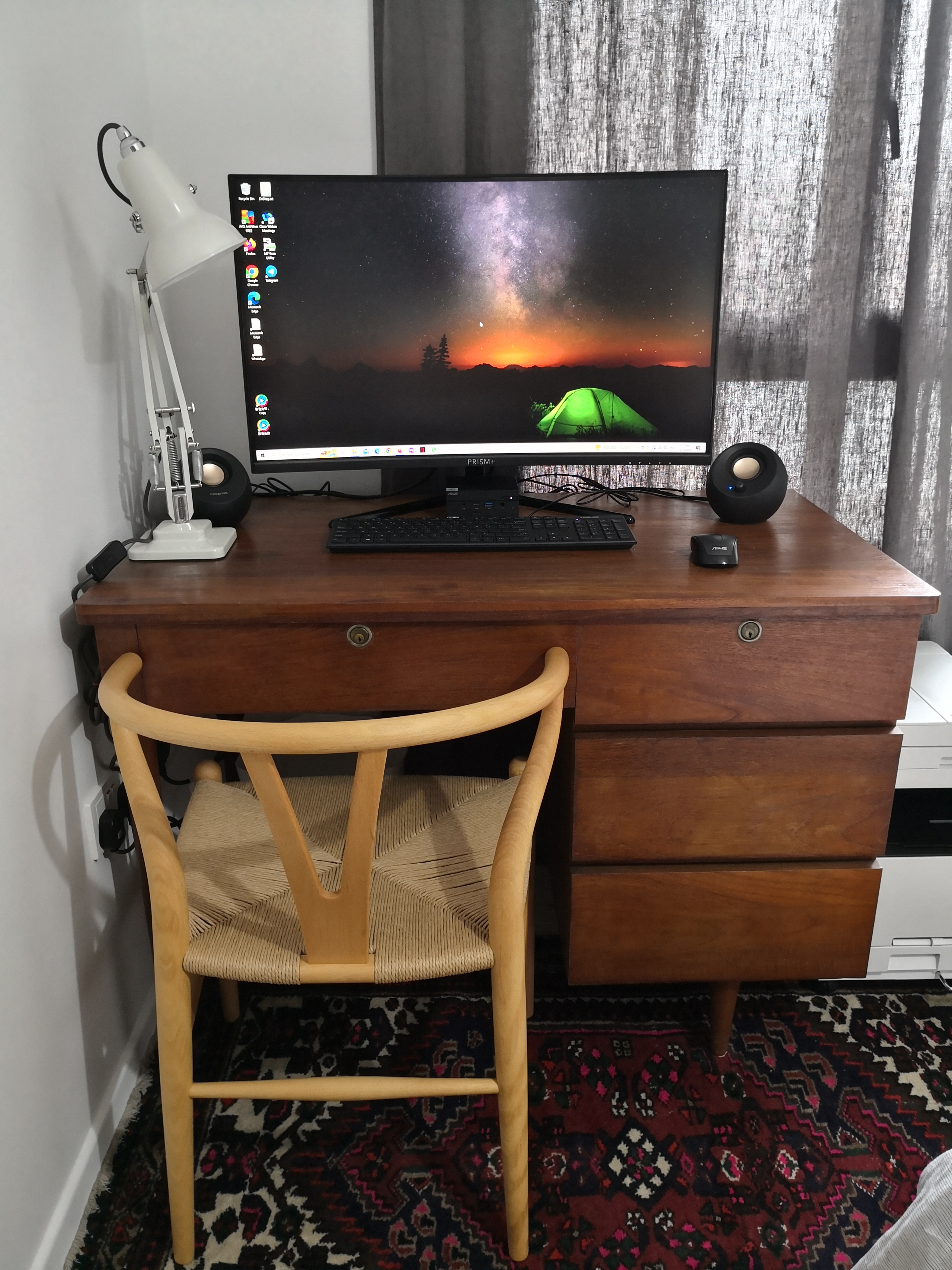 Dream A Little Dream Of Me - Wooden desk, computer monitor, black keyboard, white desk lamp, black speakers, laptop, colorful