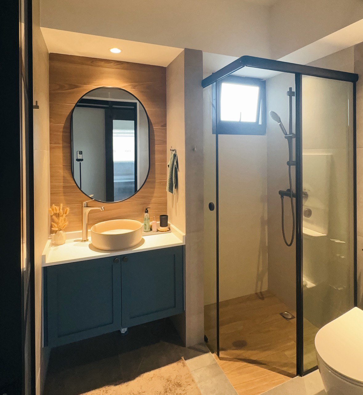 Our Render vs. Reality: 5-Room Resale - Modern bathroom with sleek design, large oval mirror, wooden accent wall, white