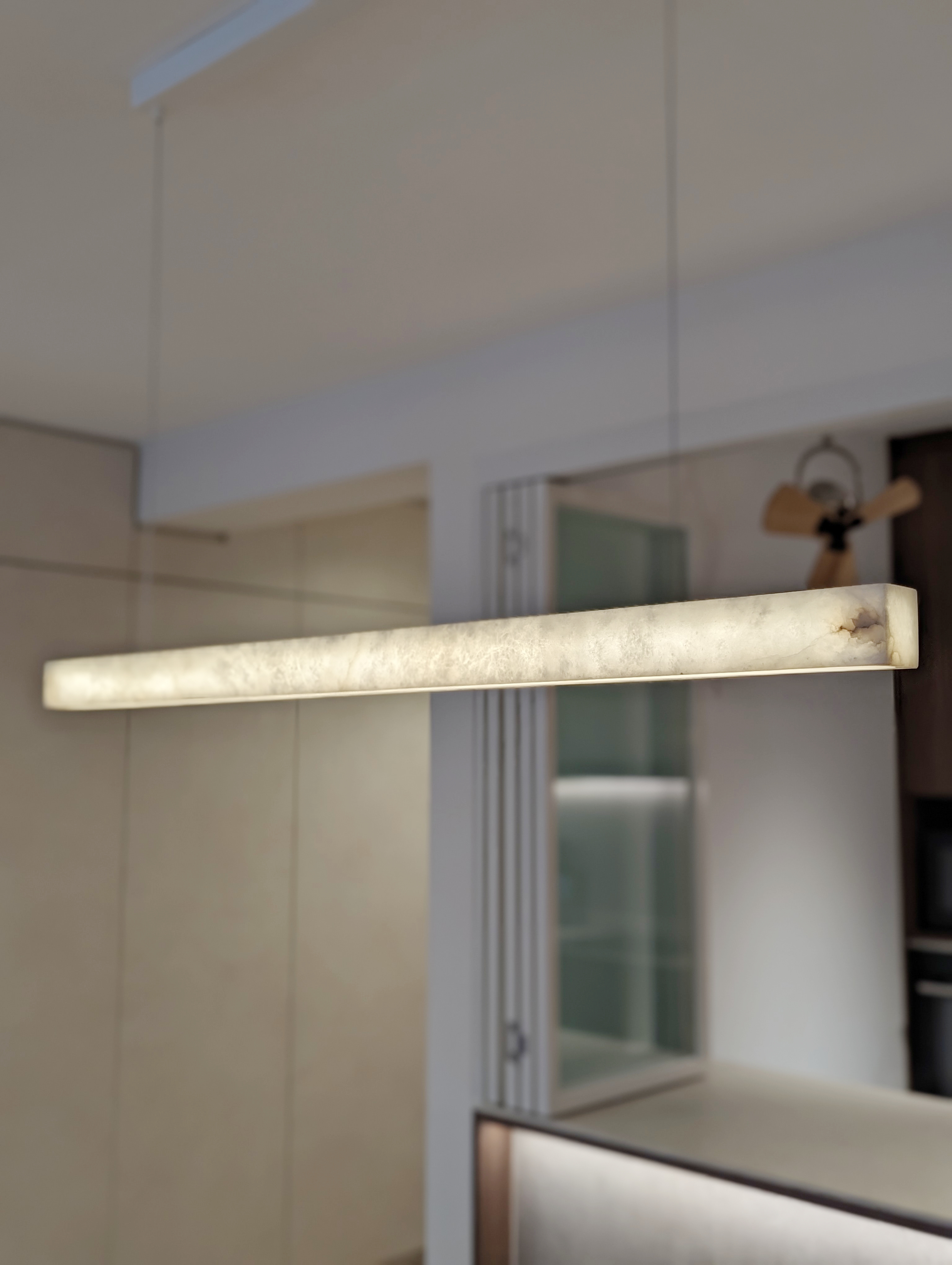 Dining Area: Sharing meals and building connections  - Modern minimalist interior, sleek pendant light fixture, neutral color