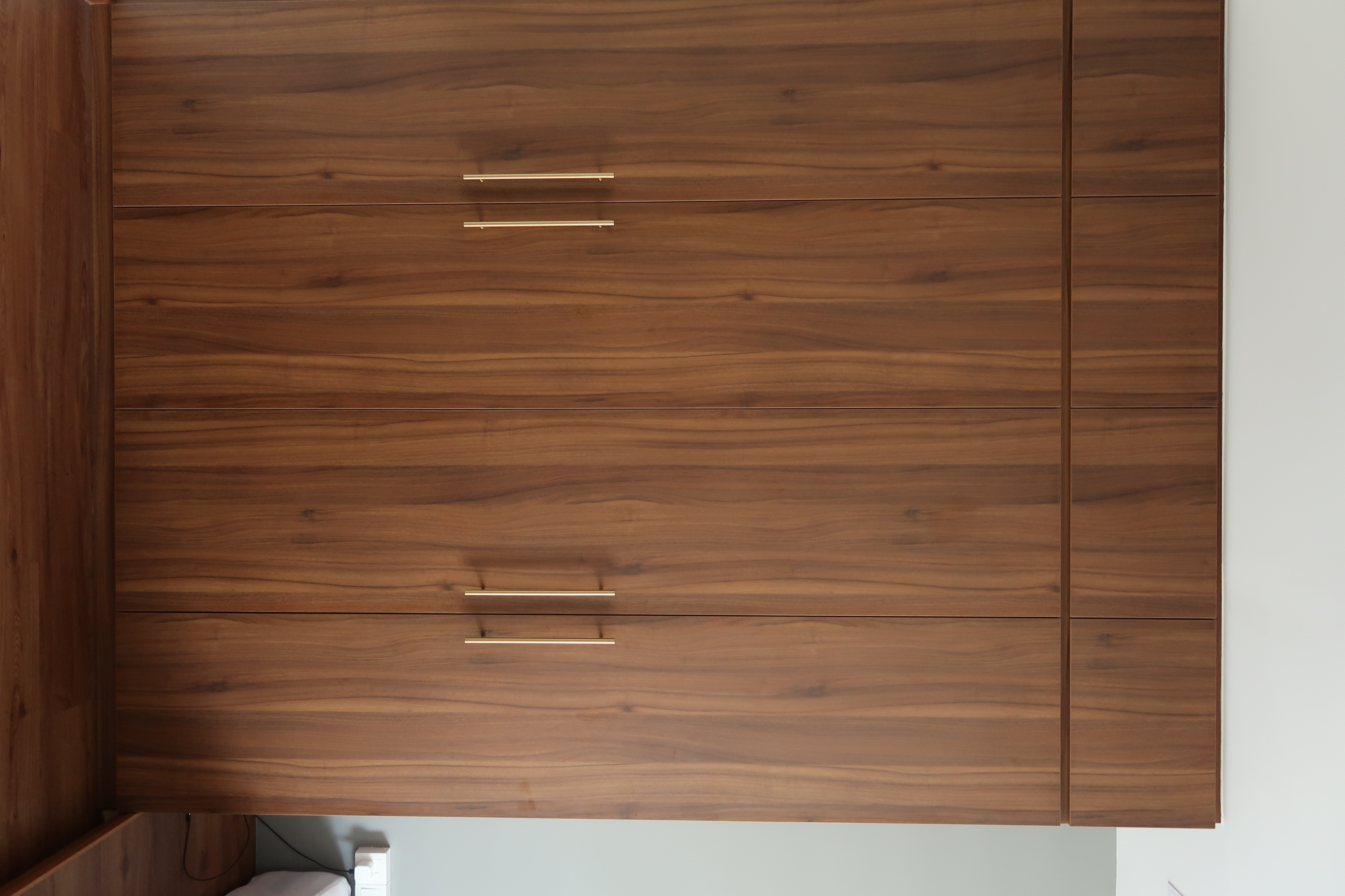 Minimal Bedroom: Our place to unwind and relax  - Wooden wardrobe with sleek, horizontal handles, polished finish, minimalist