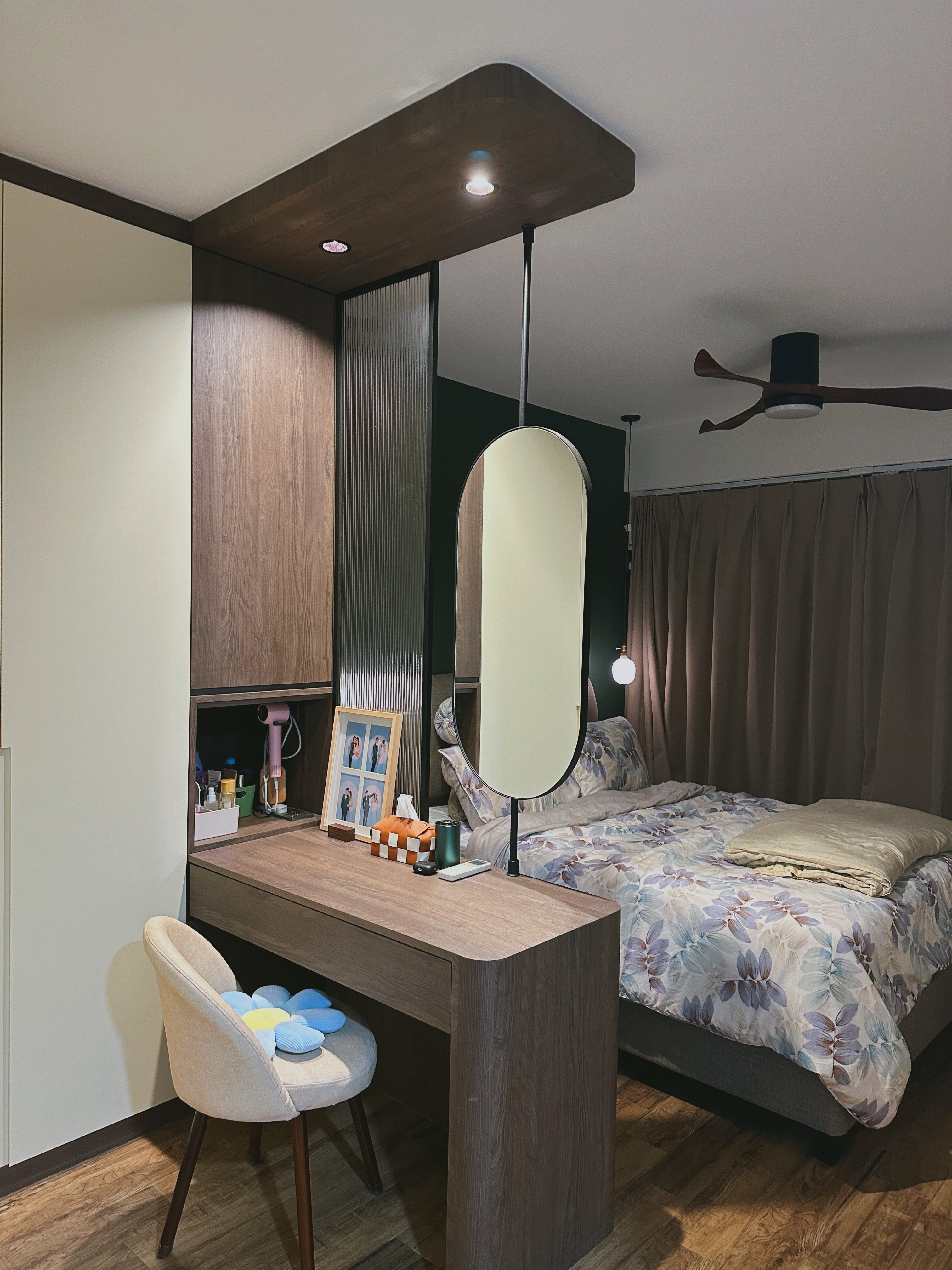 Our Bedroom: Can't get any bed-ter than this  - Wooden desk with framed photos, beige cushioned chair, floral bedspread