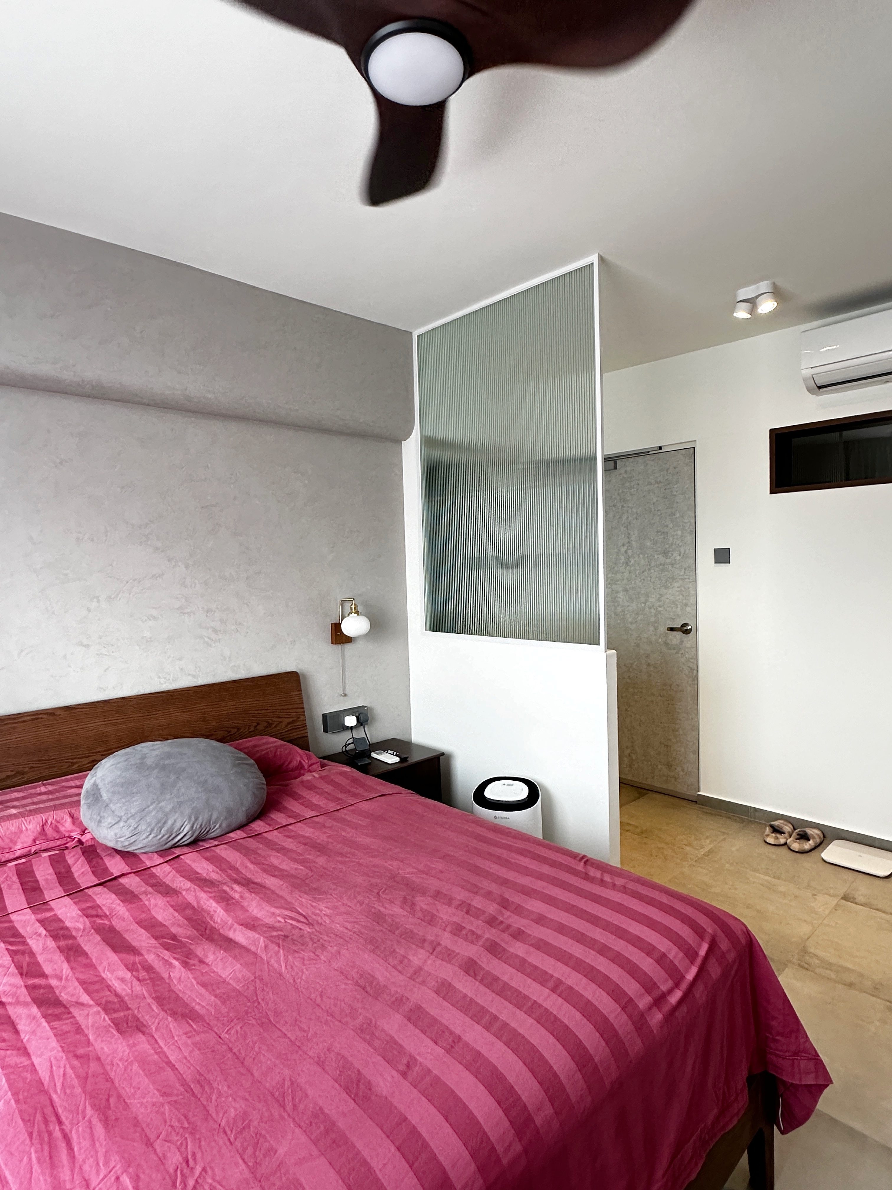 Our Bedroom Routine: Resting Zone - modern bedroom, cozy bed, pink striped bedspread, wooden headboard, gray pillow, bedside