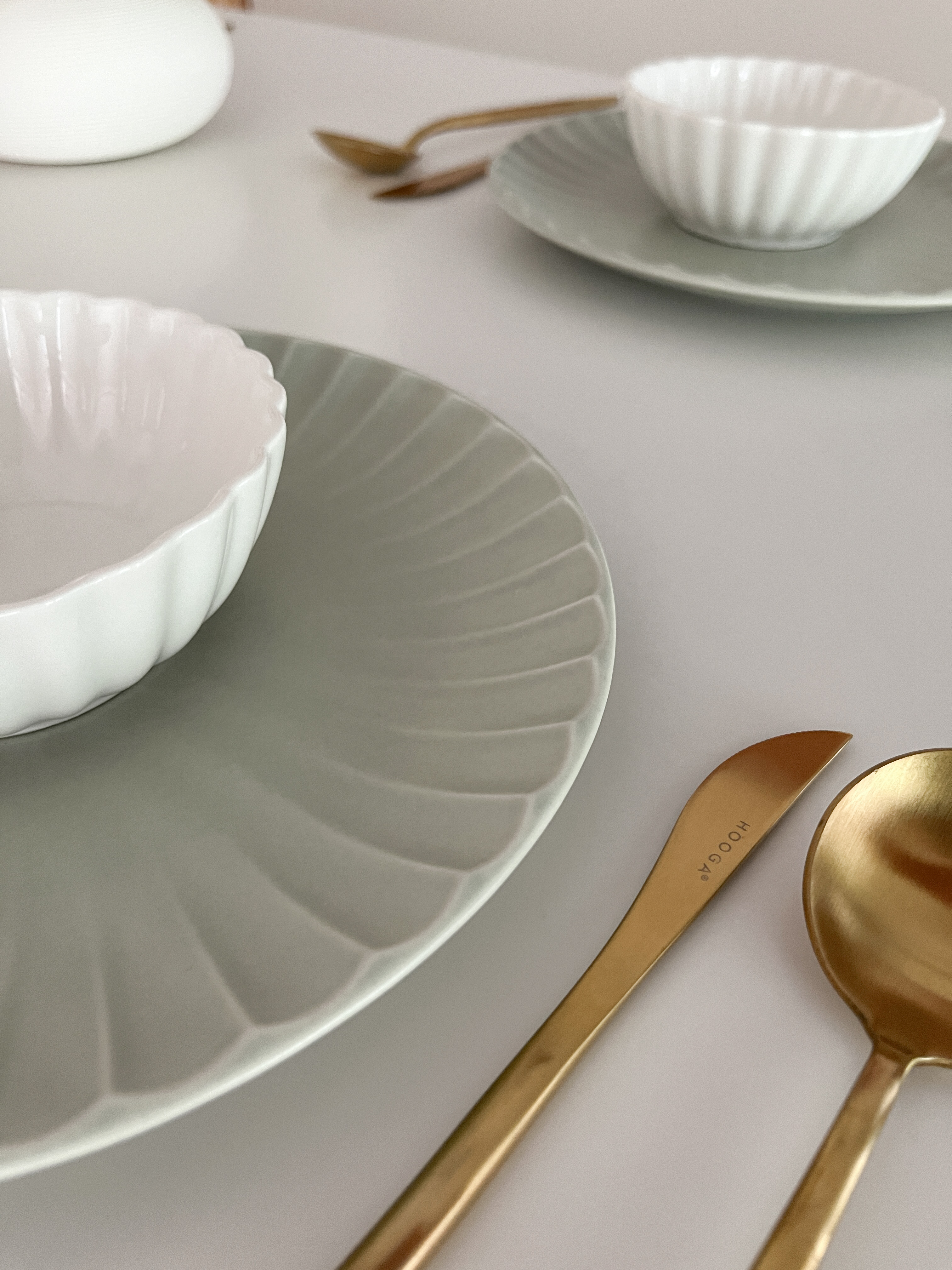 Our Dining Space: Where Lifestyle Meets Functionality - White bowl, gold spoon, gold knife, elegant table setting, minimalist