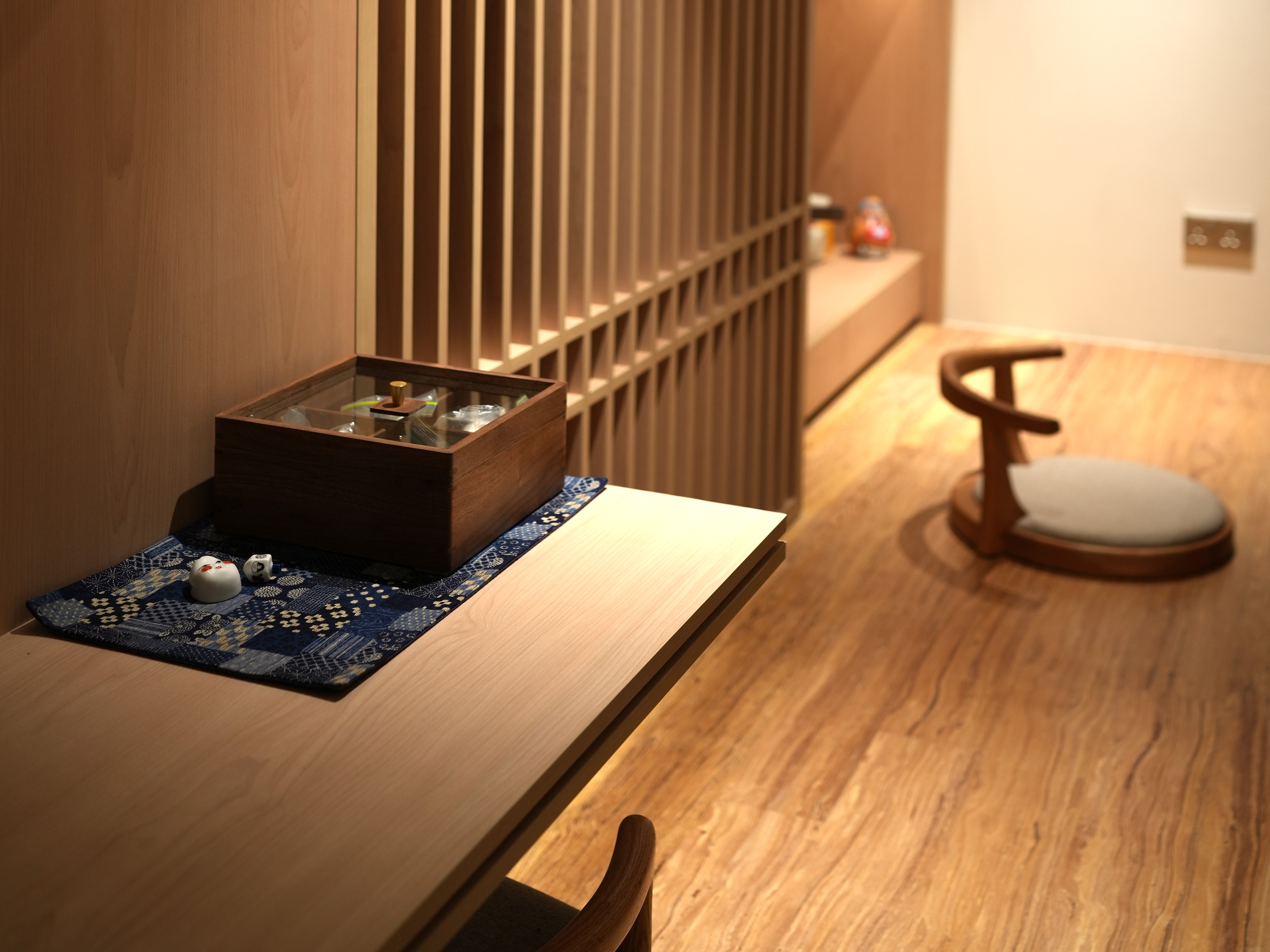 Our Living Room: Multi-Functional, Modern Japanese Versatility - Wooden table, minimalist design, wooden slatted wall, blue