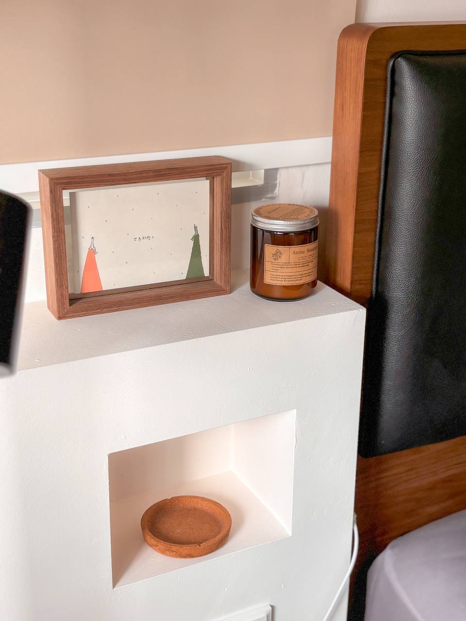 On Bedroom & Marriage Advices  - Wooden frame, framed artwork, orange dress, green dress, small shelf, white wall, black