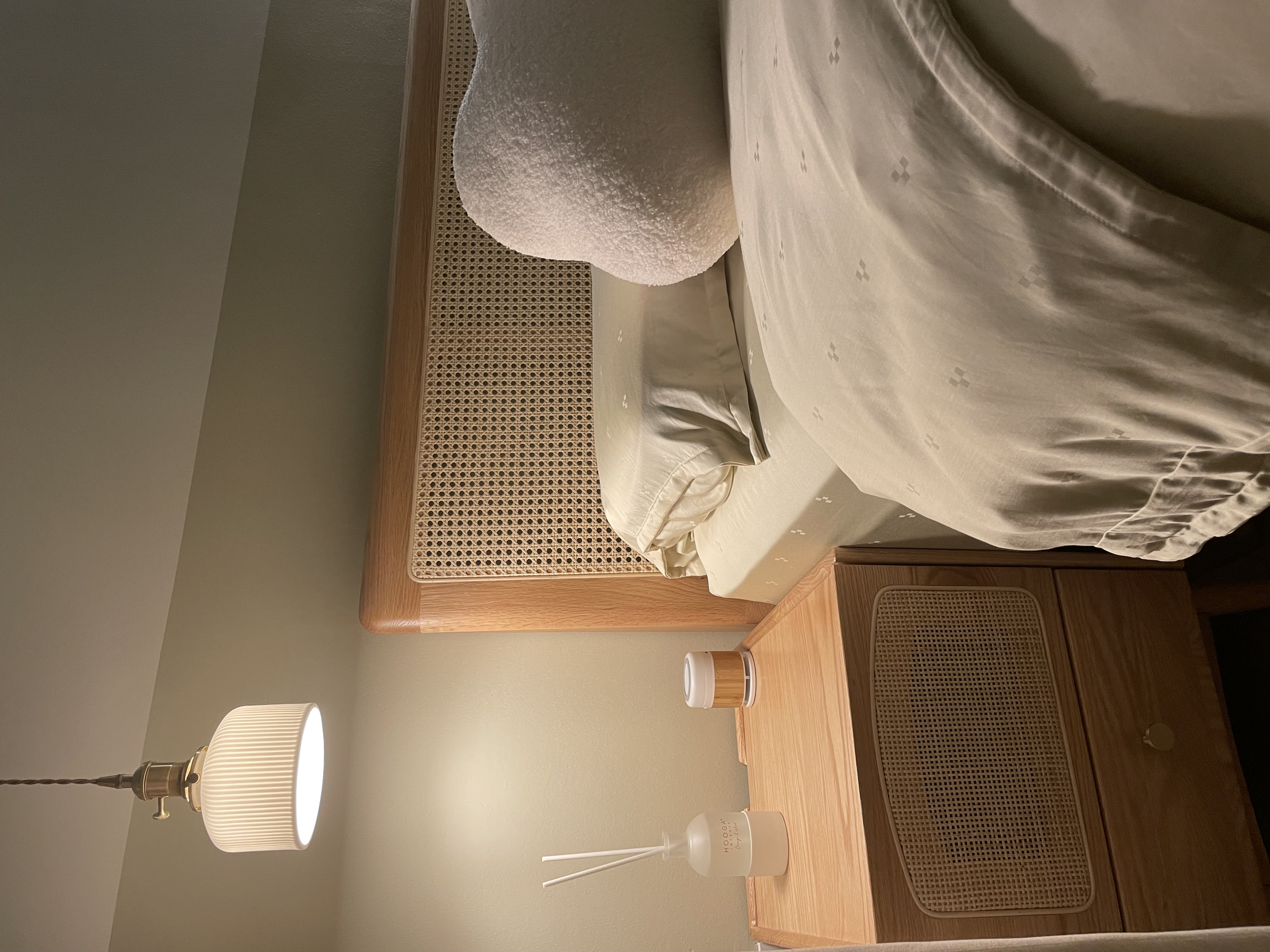 A Glimpse into Our Cozy Master Bedroom Sanctuary 🛏️🌙 - Wooden nightstand, bedside lamp, soft lighting, cozy room