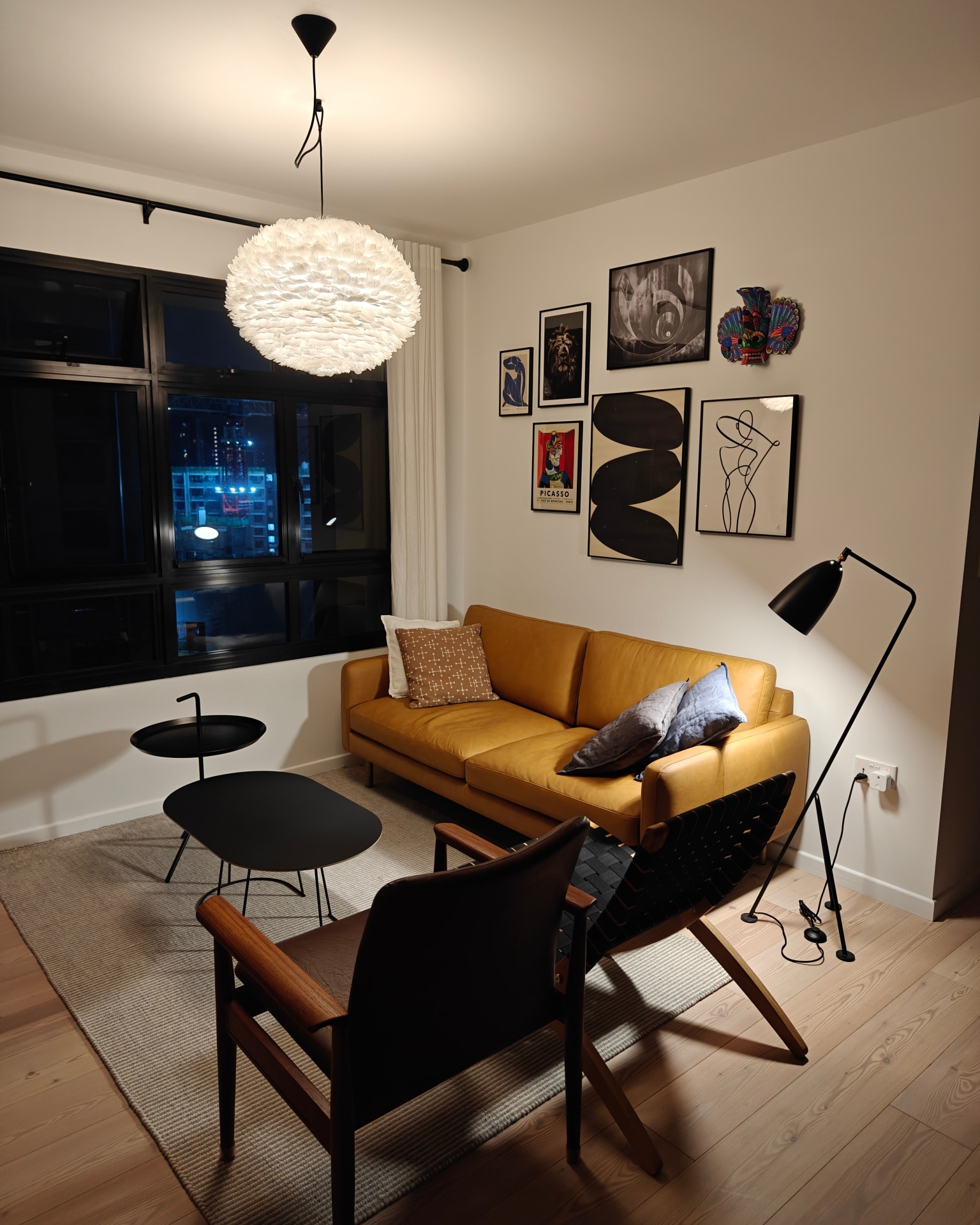 My Hyggelicious Living Room - Modern living room with mustard yellow sofa, black round coffee table, wooden chair, black