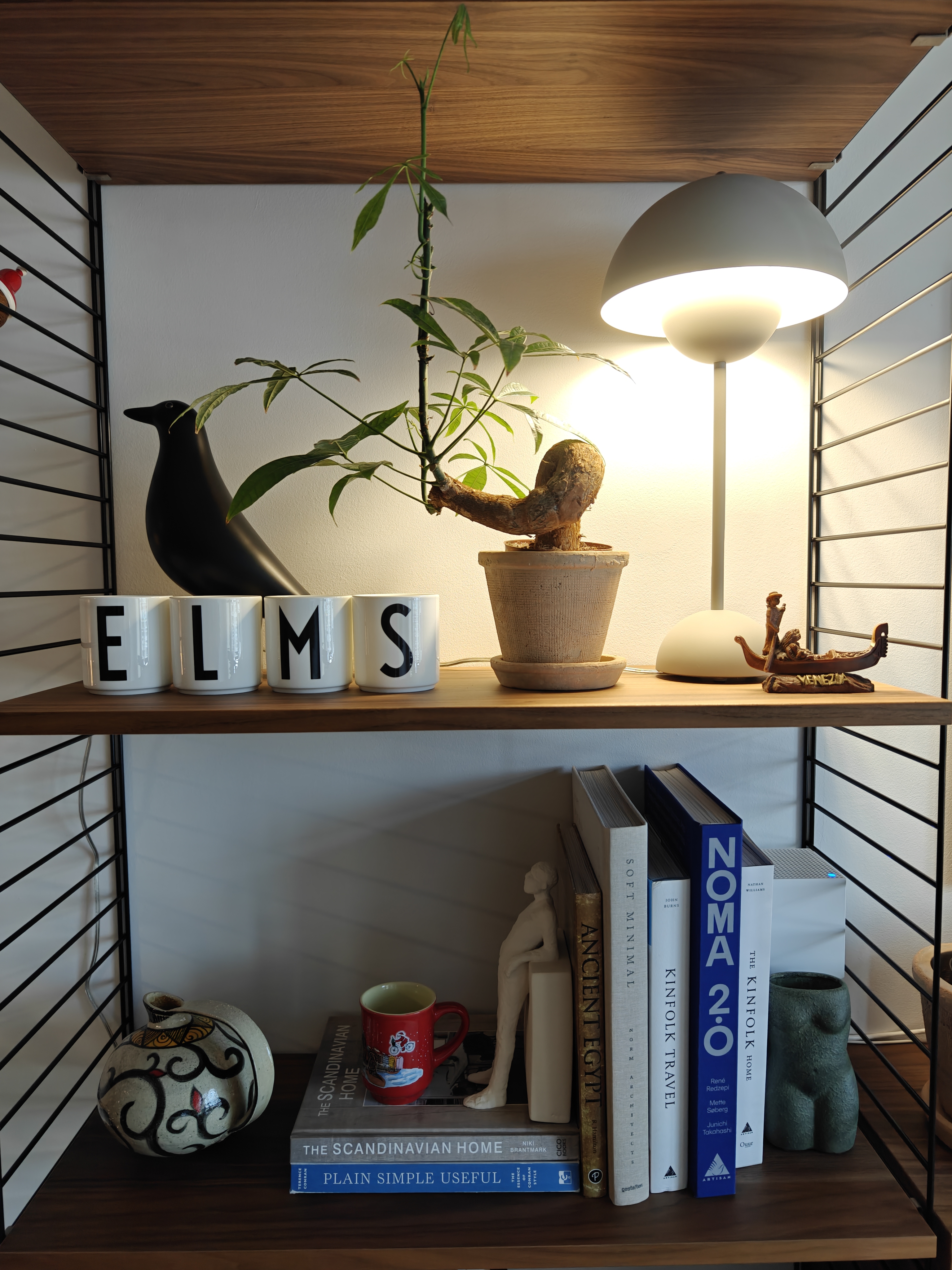My Hyggelicious Living Room - modern interior, cozy room, wooden shelves, black bird sculpture, potted plant, white mugs