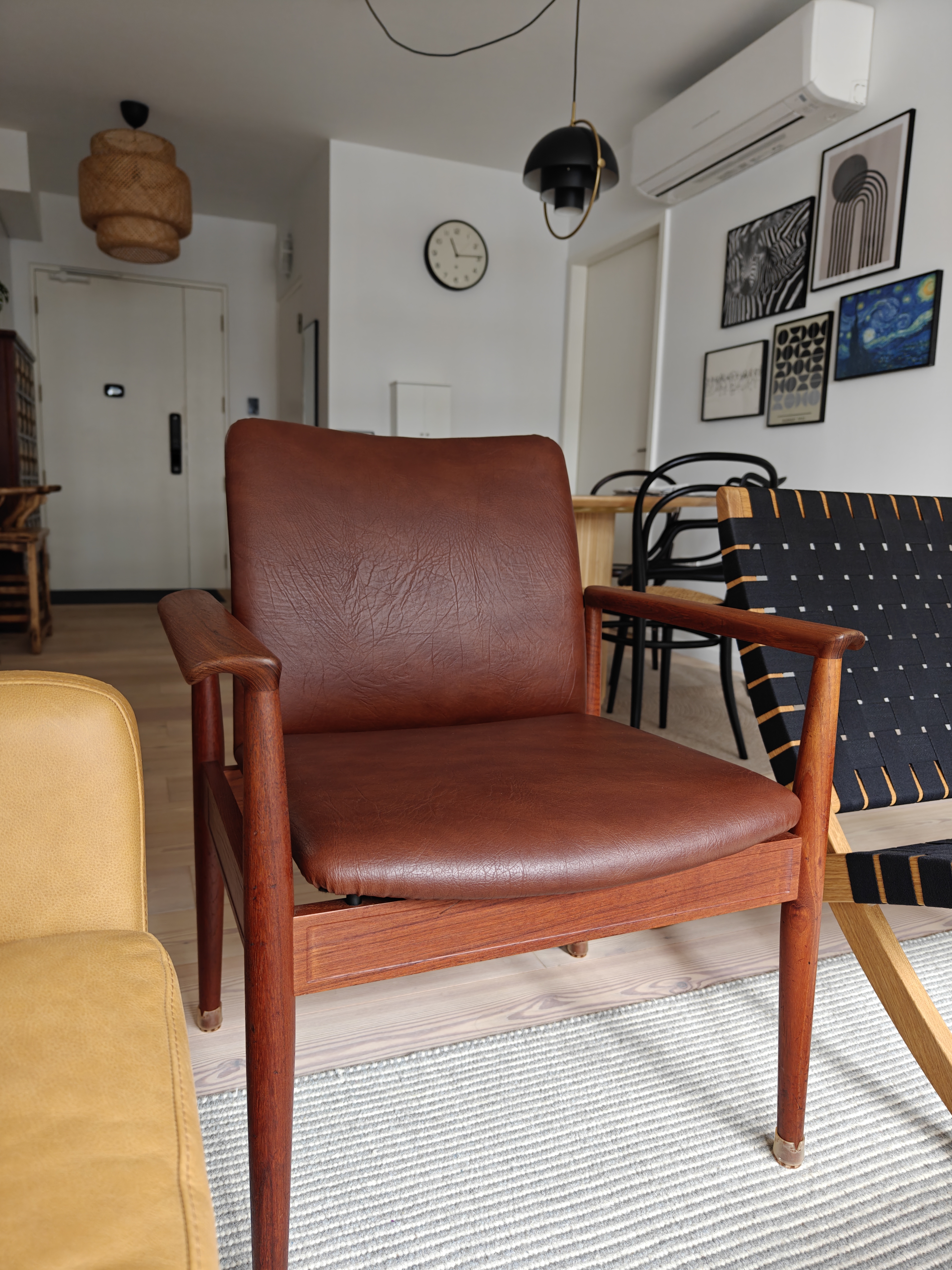 My Hyggelicious Living Room - modern living room, brown leather chair, wooden armrest, beige sofa, black and orange woven