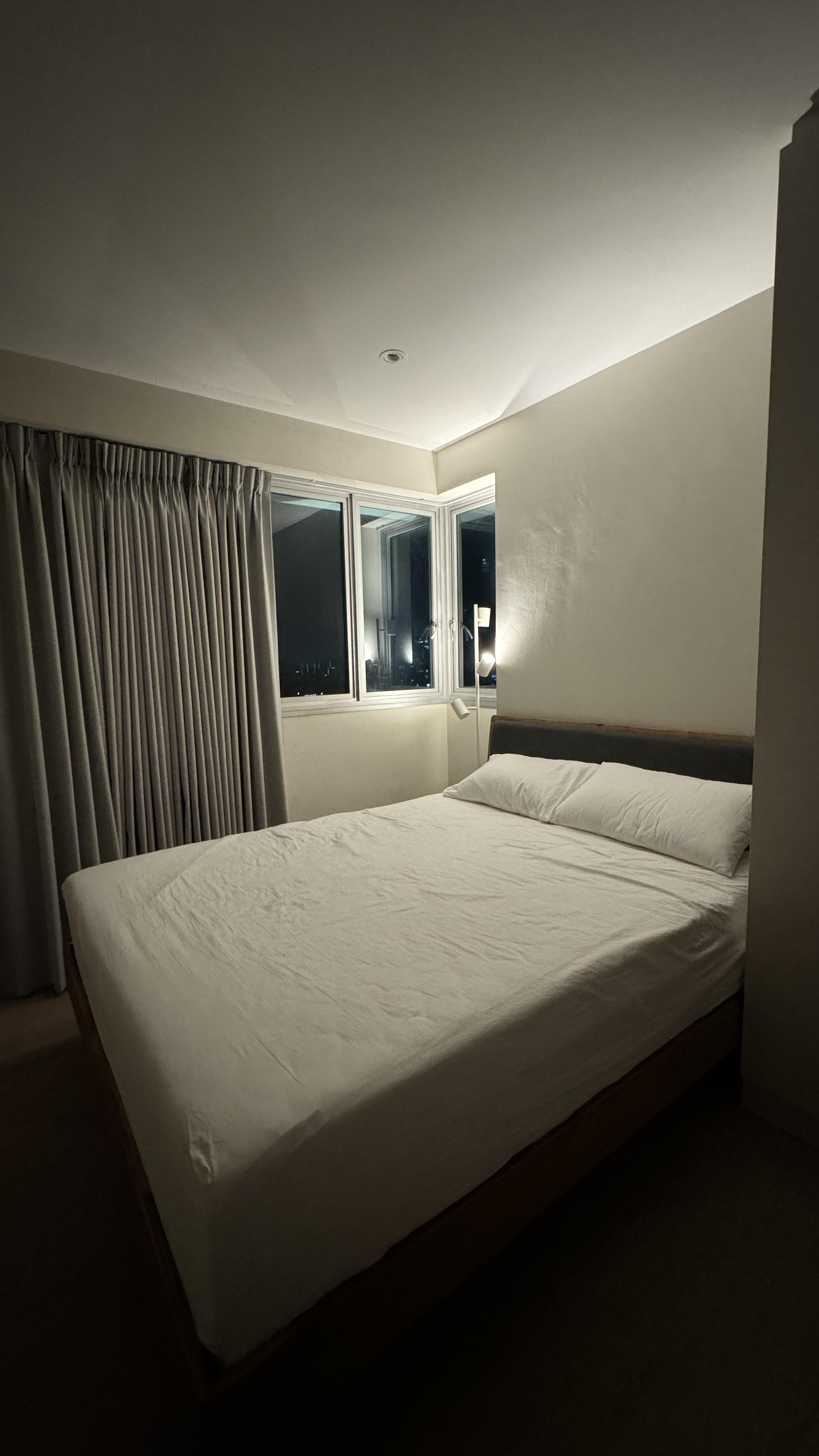 Our Bedroom: A Place Where We Can Check Out the Mood of the Sky - dimly lit bedroom, cozy atmosphere, large bed, white