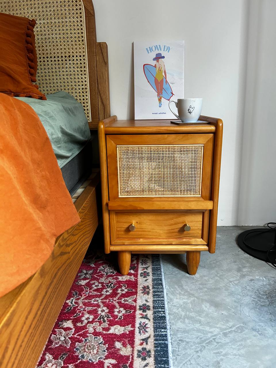Master Bedroom: Where Nothing Really Mattress - Wooden nightstand with woven front panel, orange throw blanket, blue-green