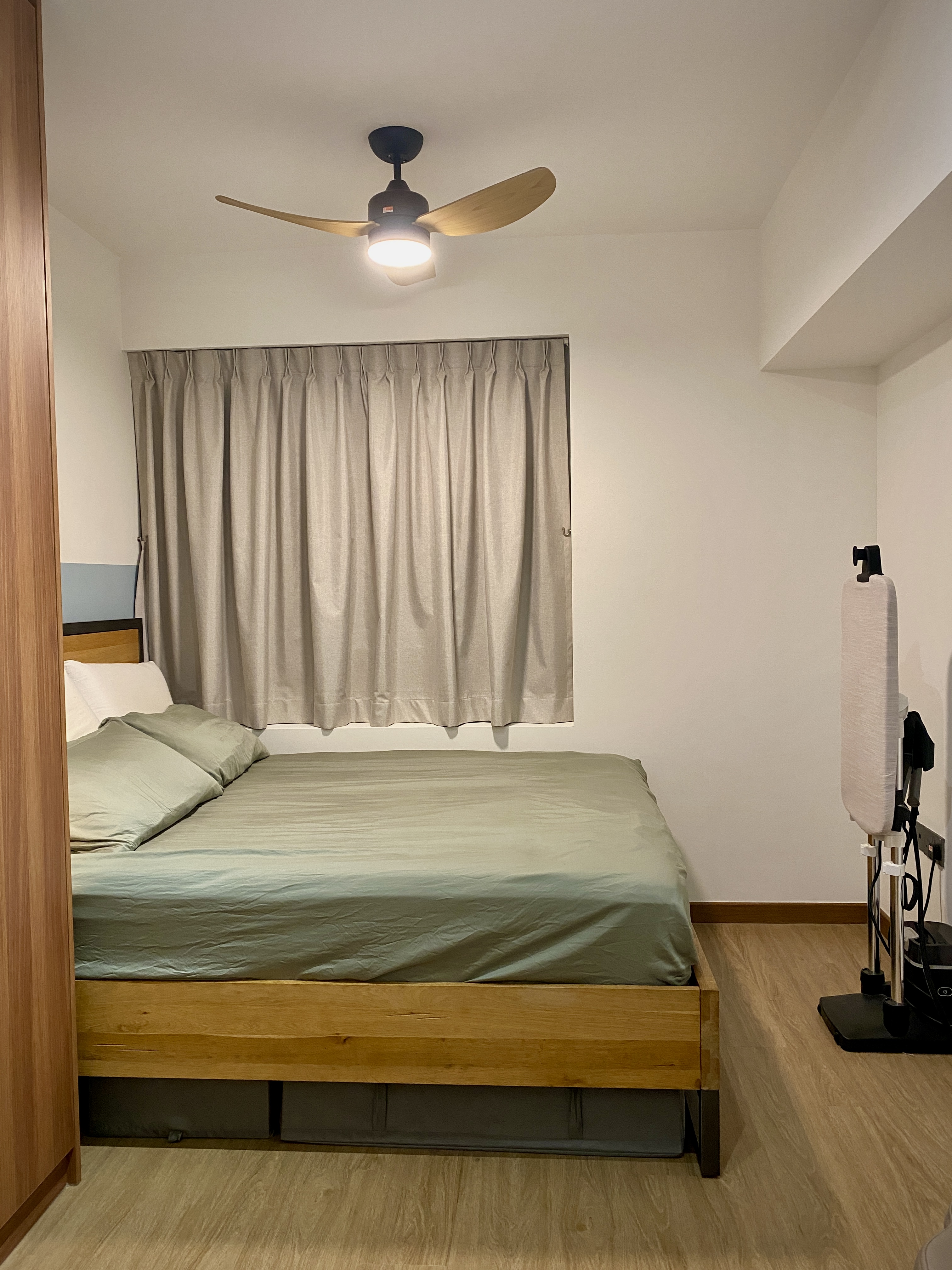 Our Restful Haven: Comfy Bed, Blackout Curtains and Ambient Light - Wooden-framed mirror, light fixture, beige curtains