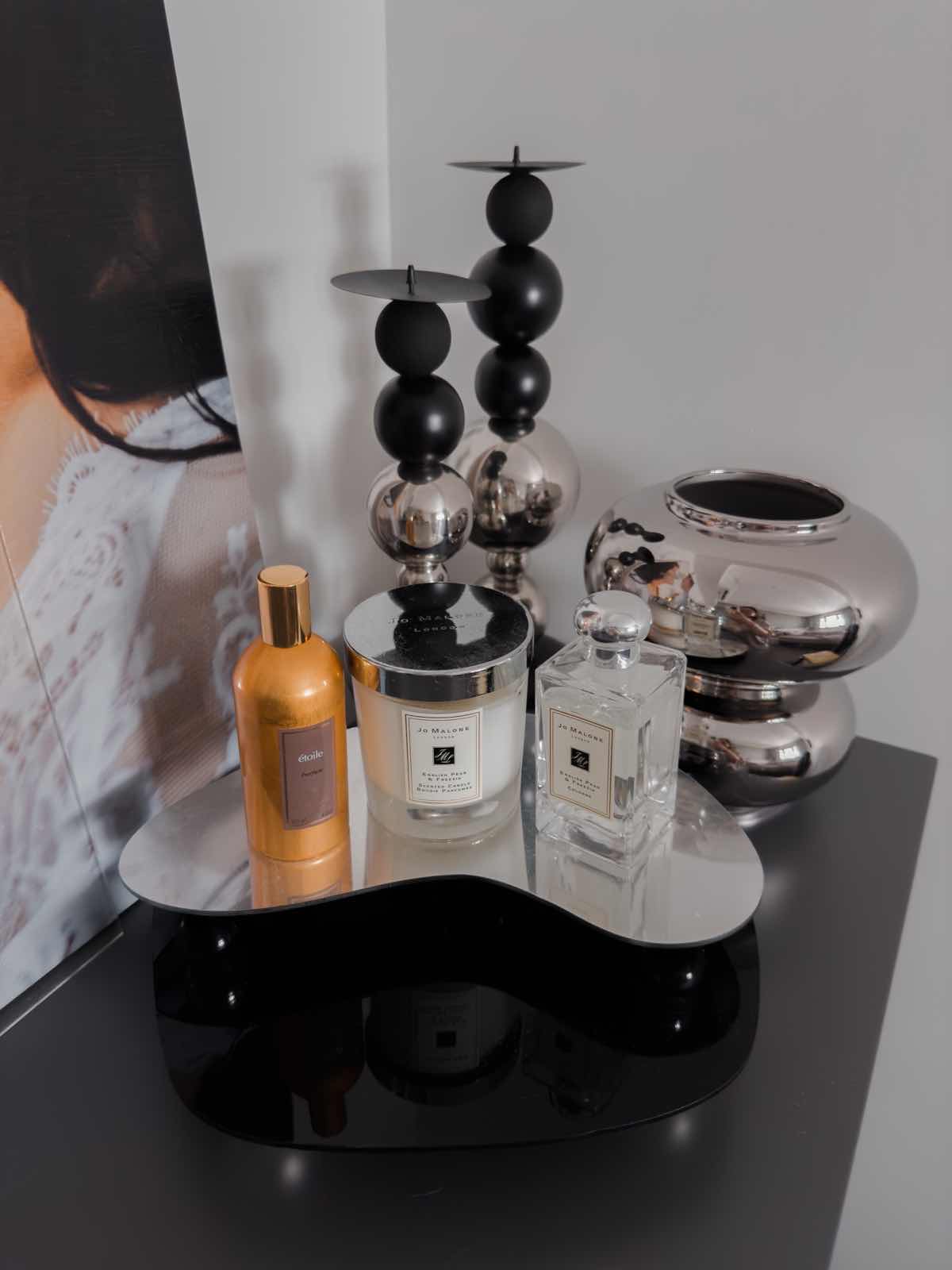Pillow Talk: Bedroom of Decluttered Space & Mind - Barrel, perfume bottle, candle, glass jar, metallic stand, black and gold