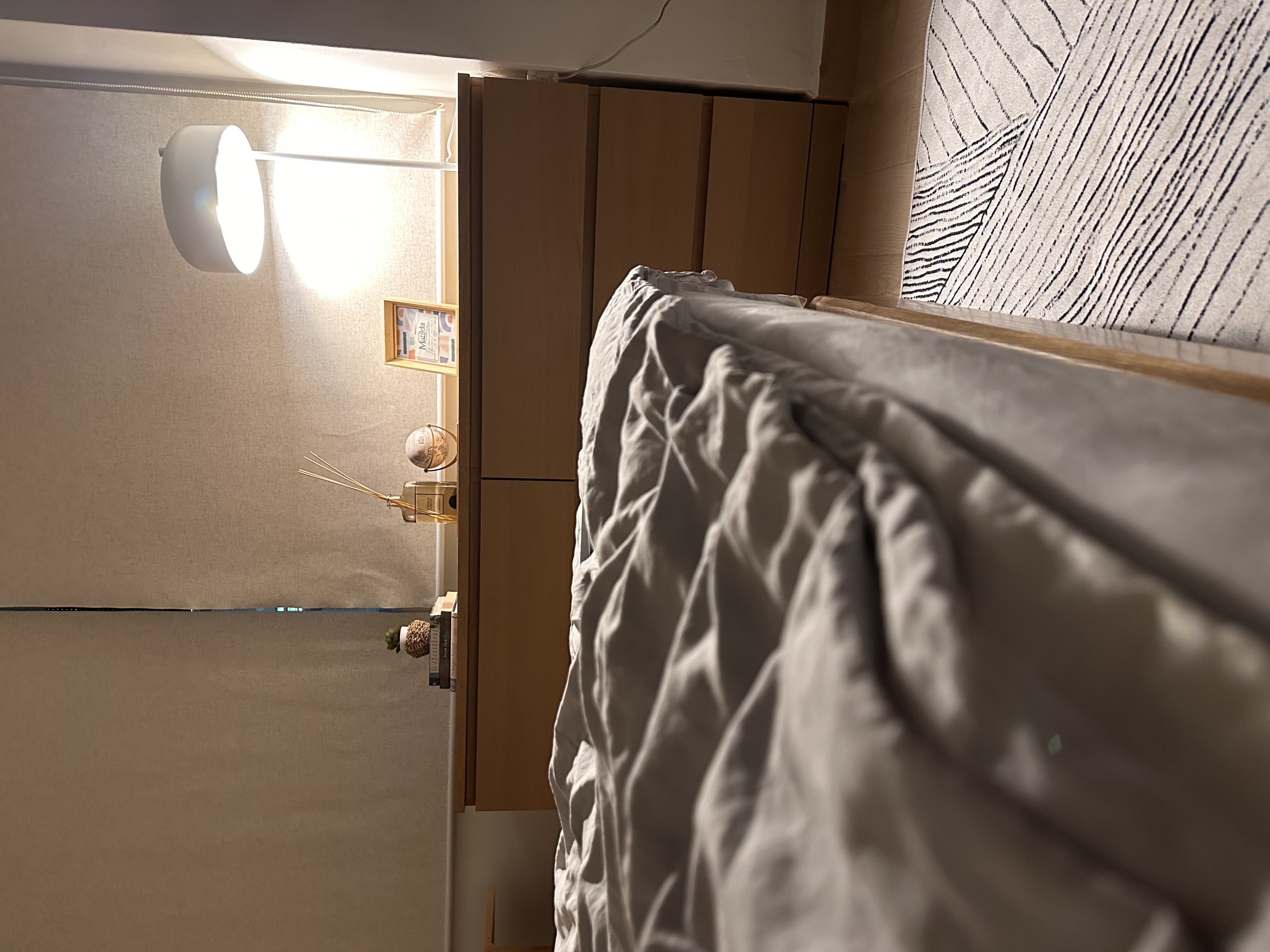 Warm fuzzy cosy nook to wind down - modern bedroom, cozy room, soft lighting, wooden furniture, textured wall, bedside table