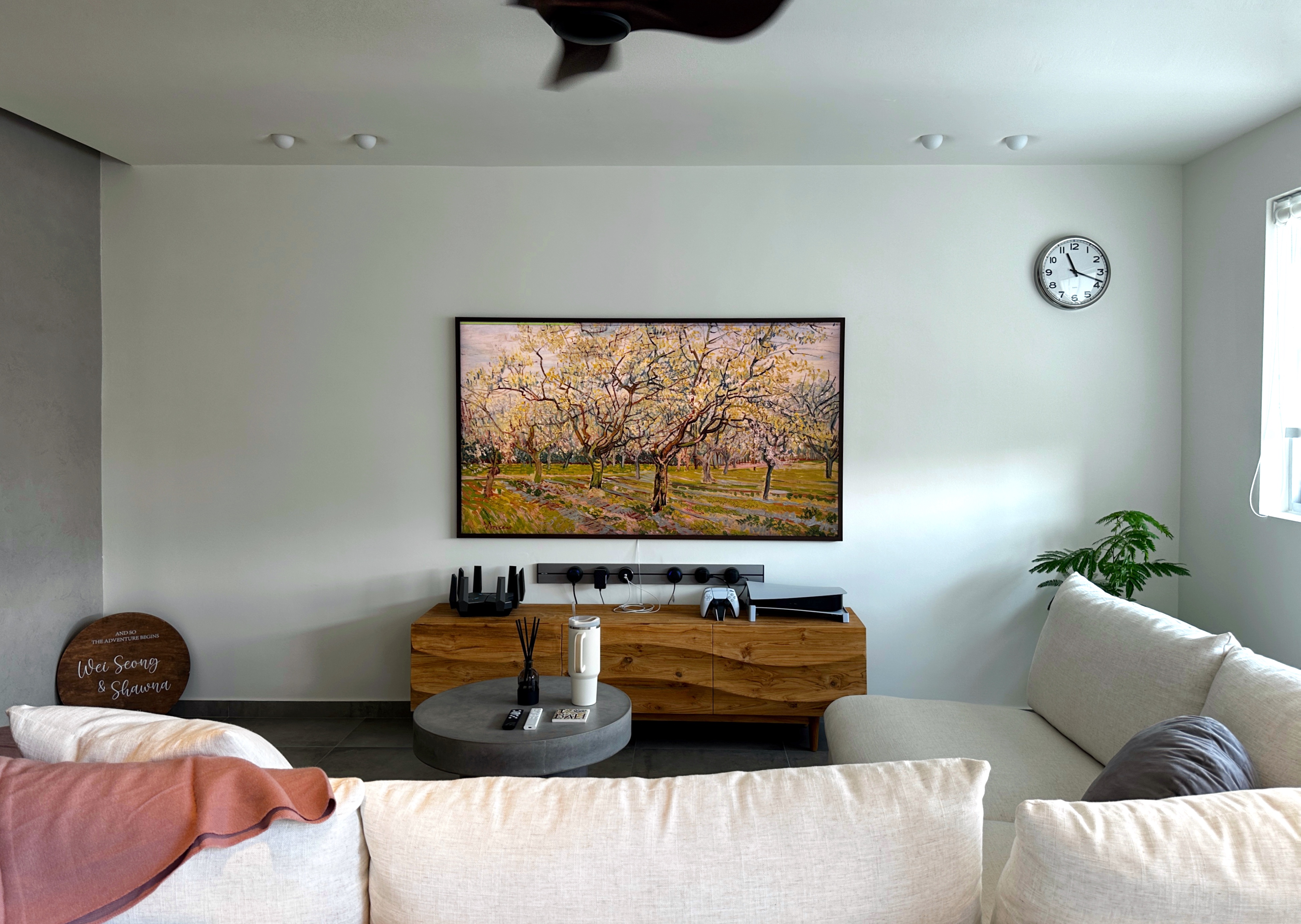 Living Room: Our Oasis with no built-in! - Modern living room with minimalist design, beige sofa, wooden coffee table, potted