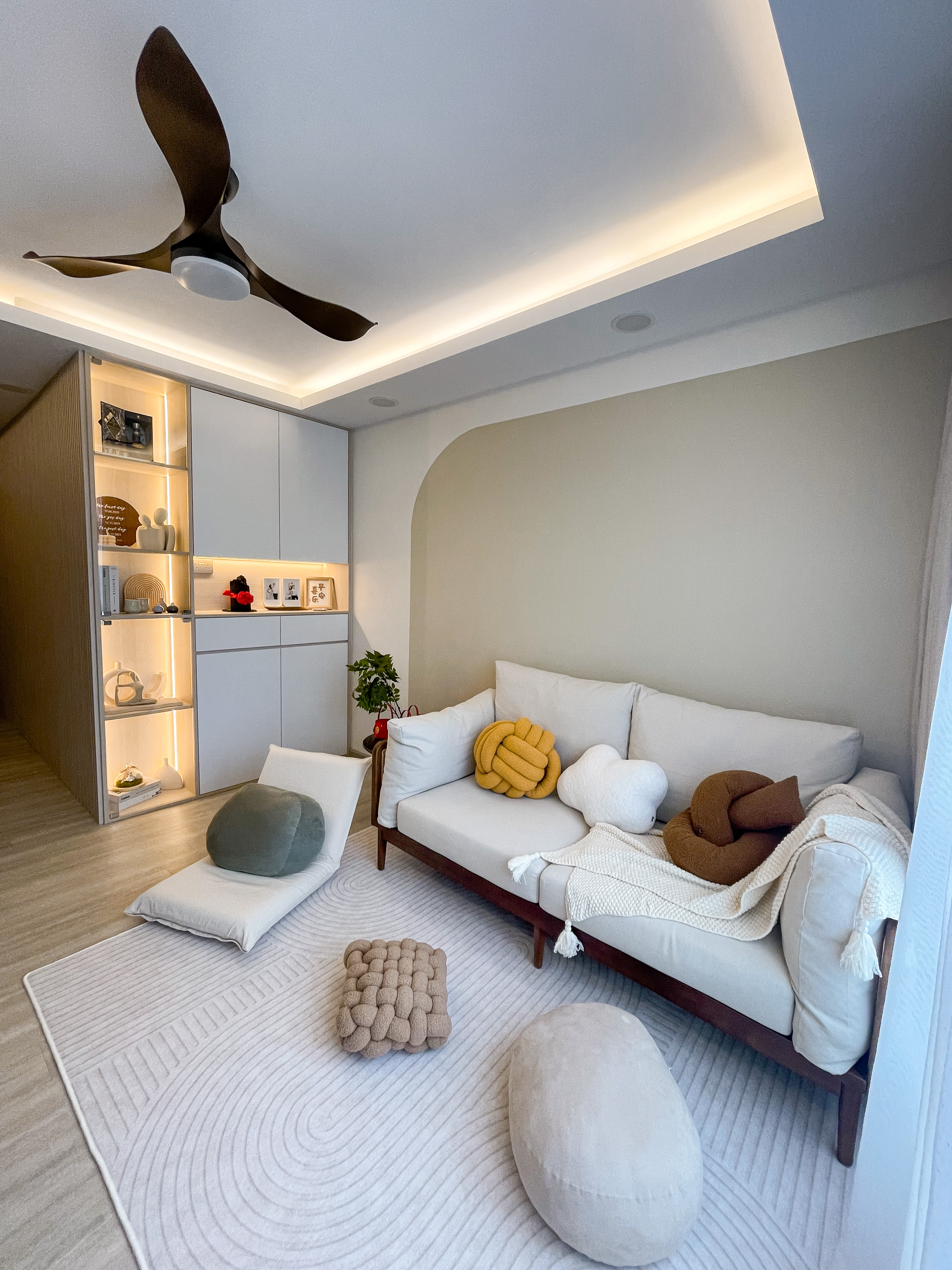 Living Room: Embracing Nordic Warmth with Wooden and Rattan Accents - Modern living room with sleek ceiling fan, minimalist