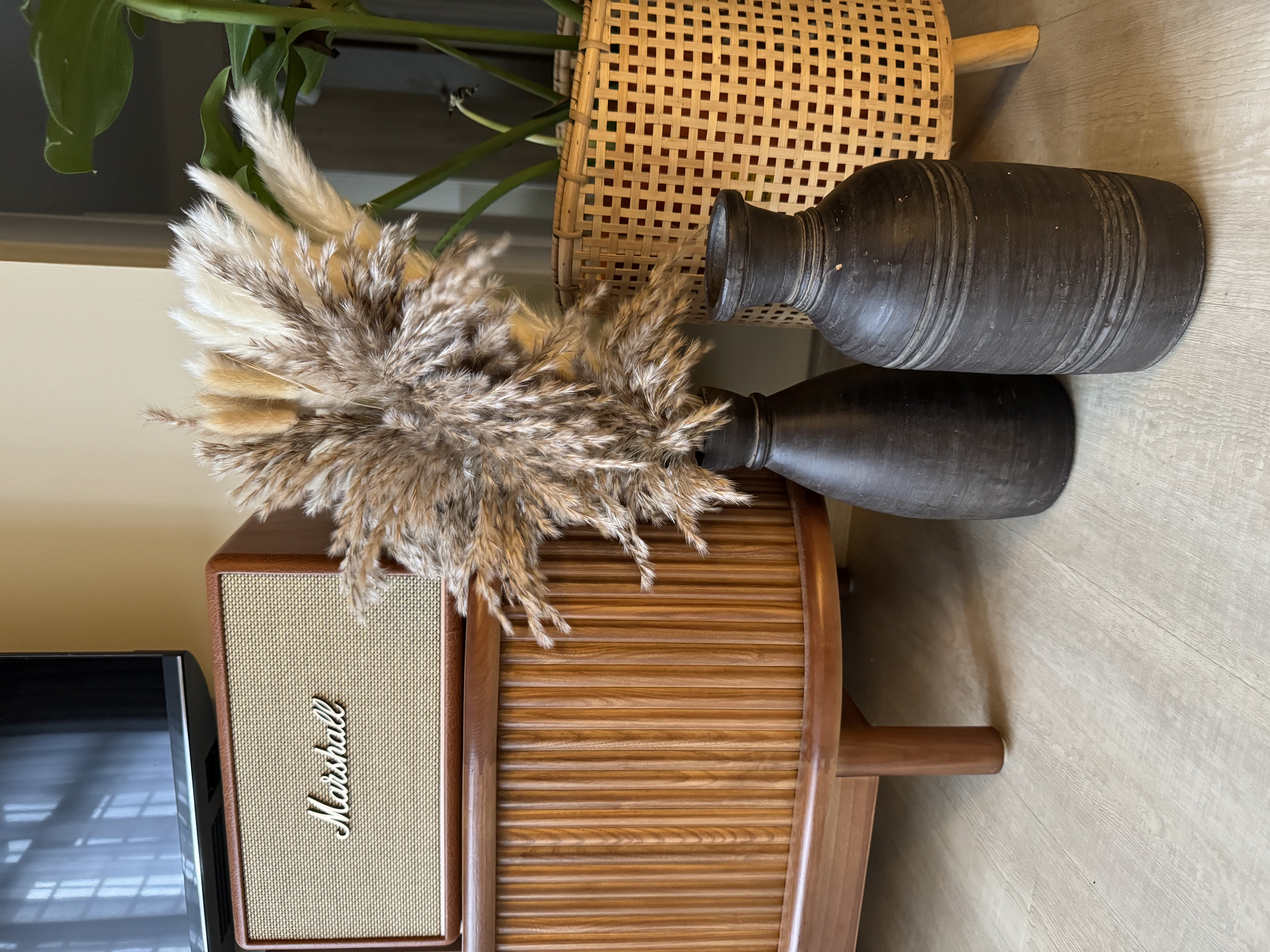 Living Room: Embracing Nordic Warmth with Wooden and Rattan Accents - Fur pom-pom, vintage radio, wooden stand, wicker chair