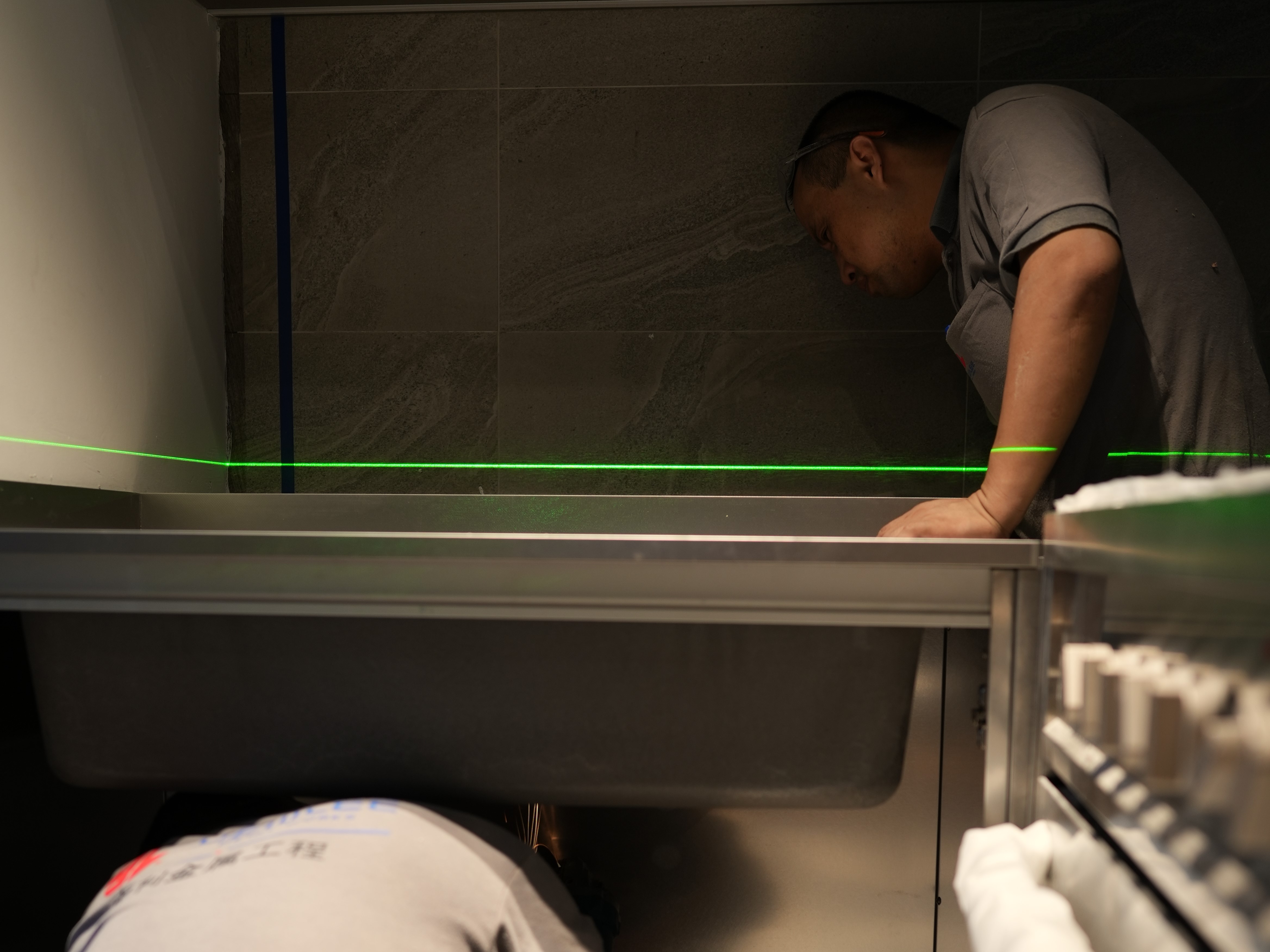 Costs: Financing Your Pinterest Moodboards Without Getting Divorced - green laser, man working, tiled wall, dark room