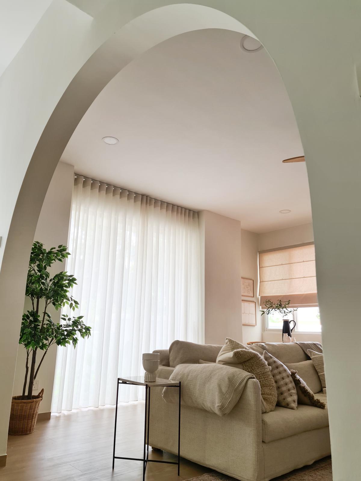 Our bright and airy Minimalist living room  - Arched doorway, modern living room, beige sofa, textured cushions, large