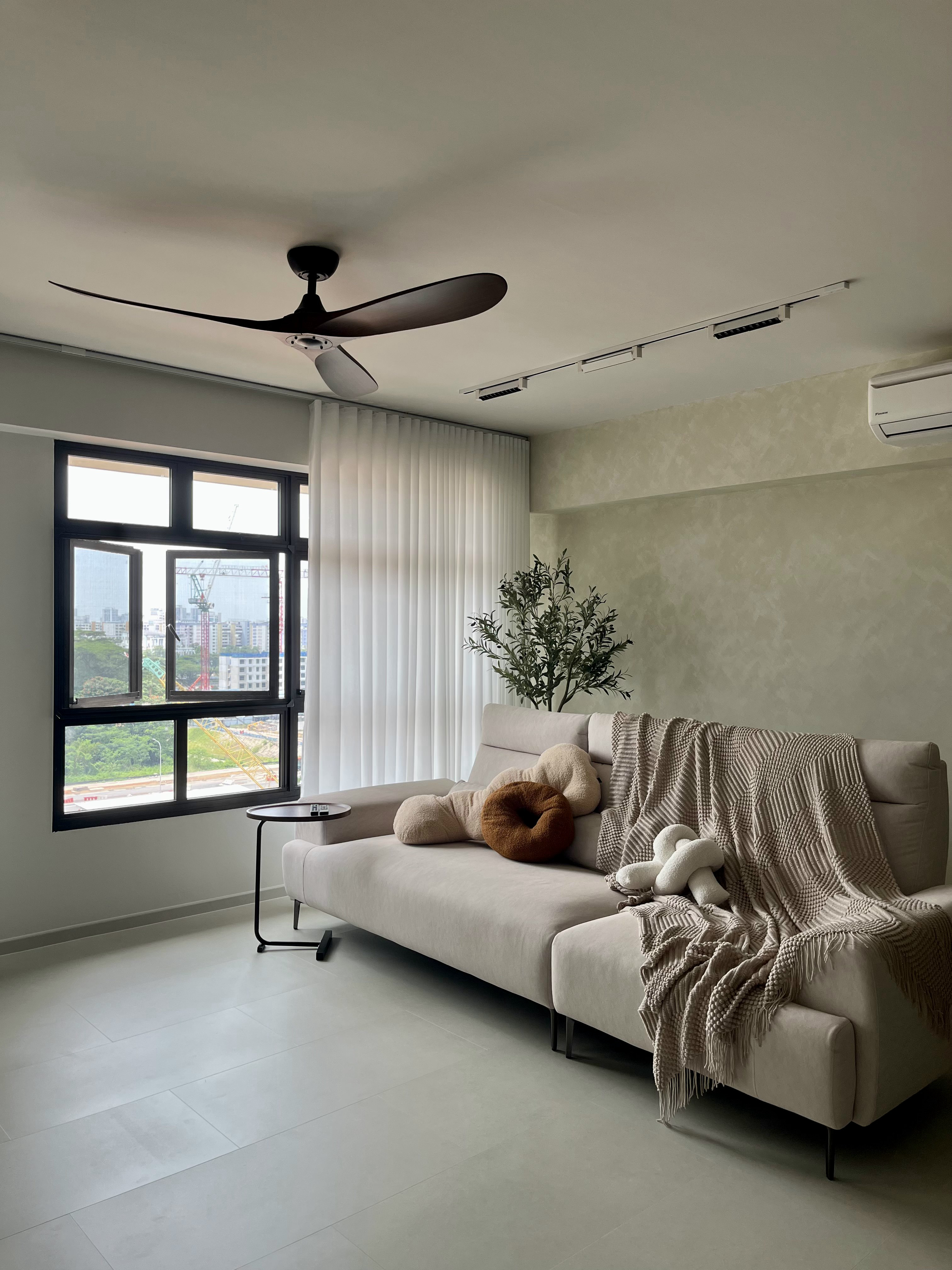 Welcome Home: A "Sand-sory" Escape - Modern minimalist living room, neutral color palette, large window with white blinds