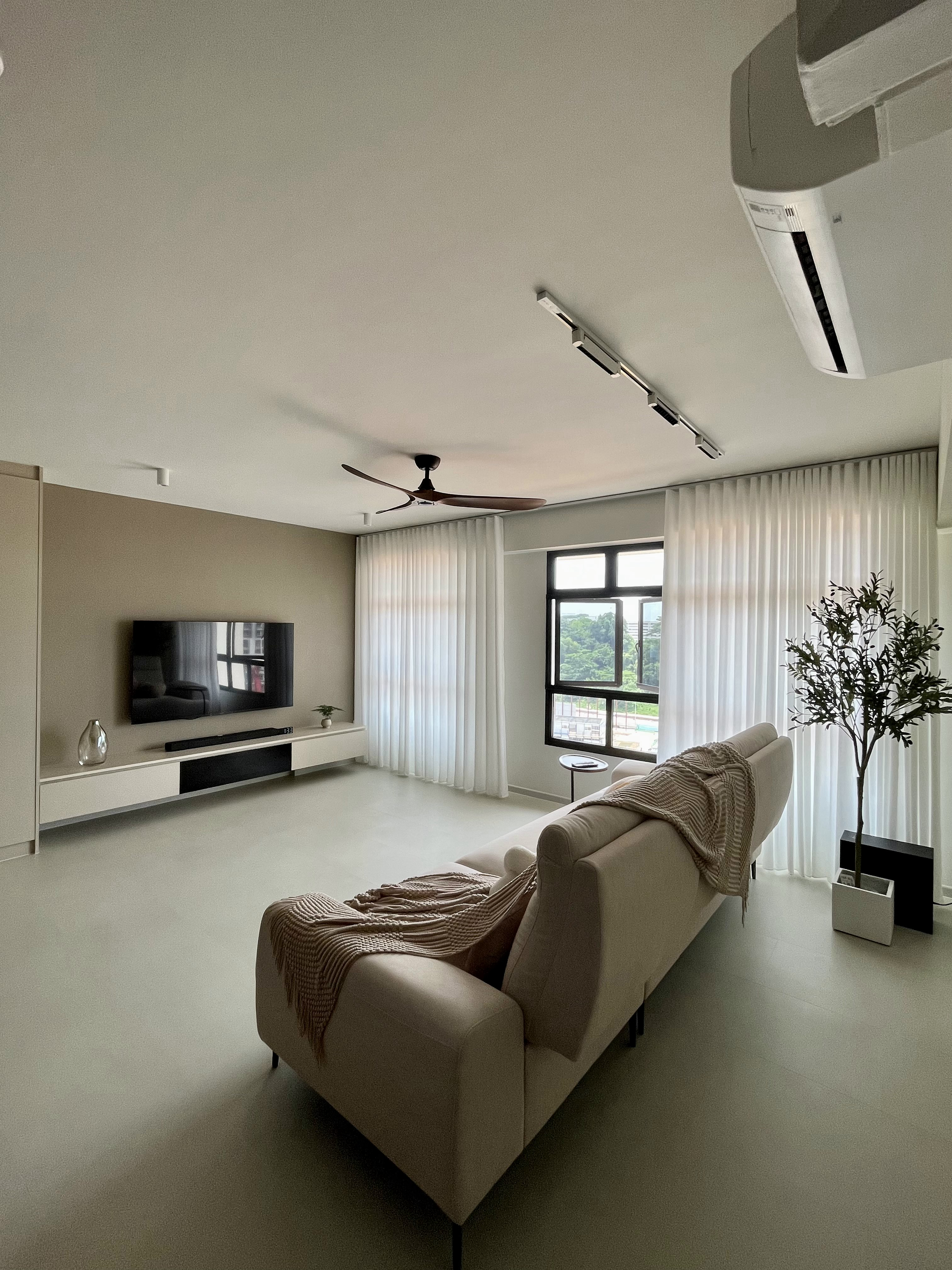 Welcome Home: A "Sand-sory" Escape - Modern minimalist living room, spacious and airy, large window with white curtains