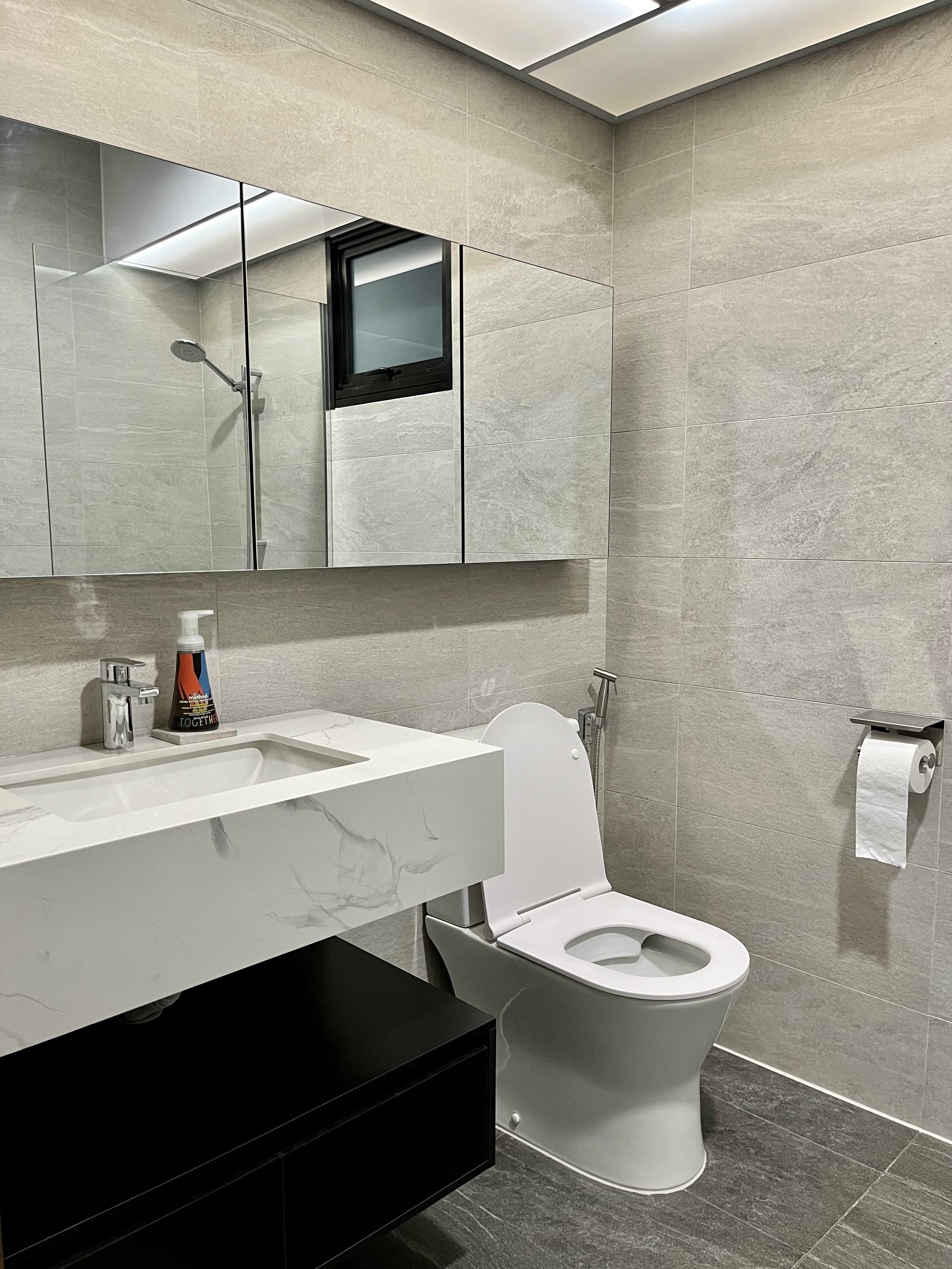 Welcome Home: A "Sand-sory" Escape - Modern bathroom with sleek design, beige marble tiles, large mirror, white sink with