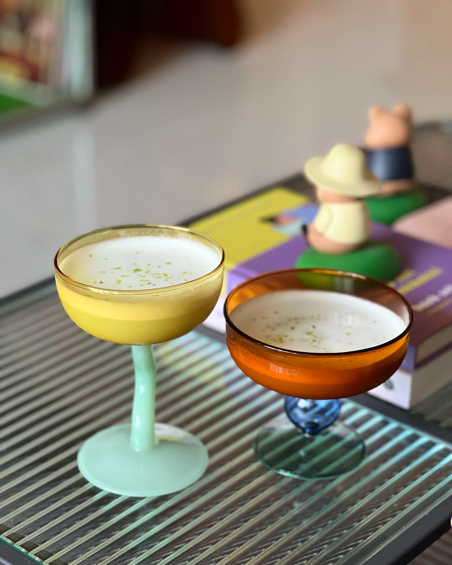A Playground for Conversations  - Glowing cocktail glasses, vibrant yellow and orange drinks, colorful drink containers, soft