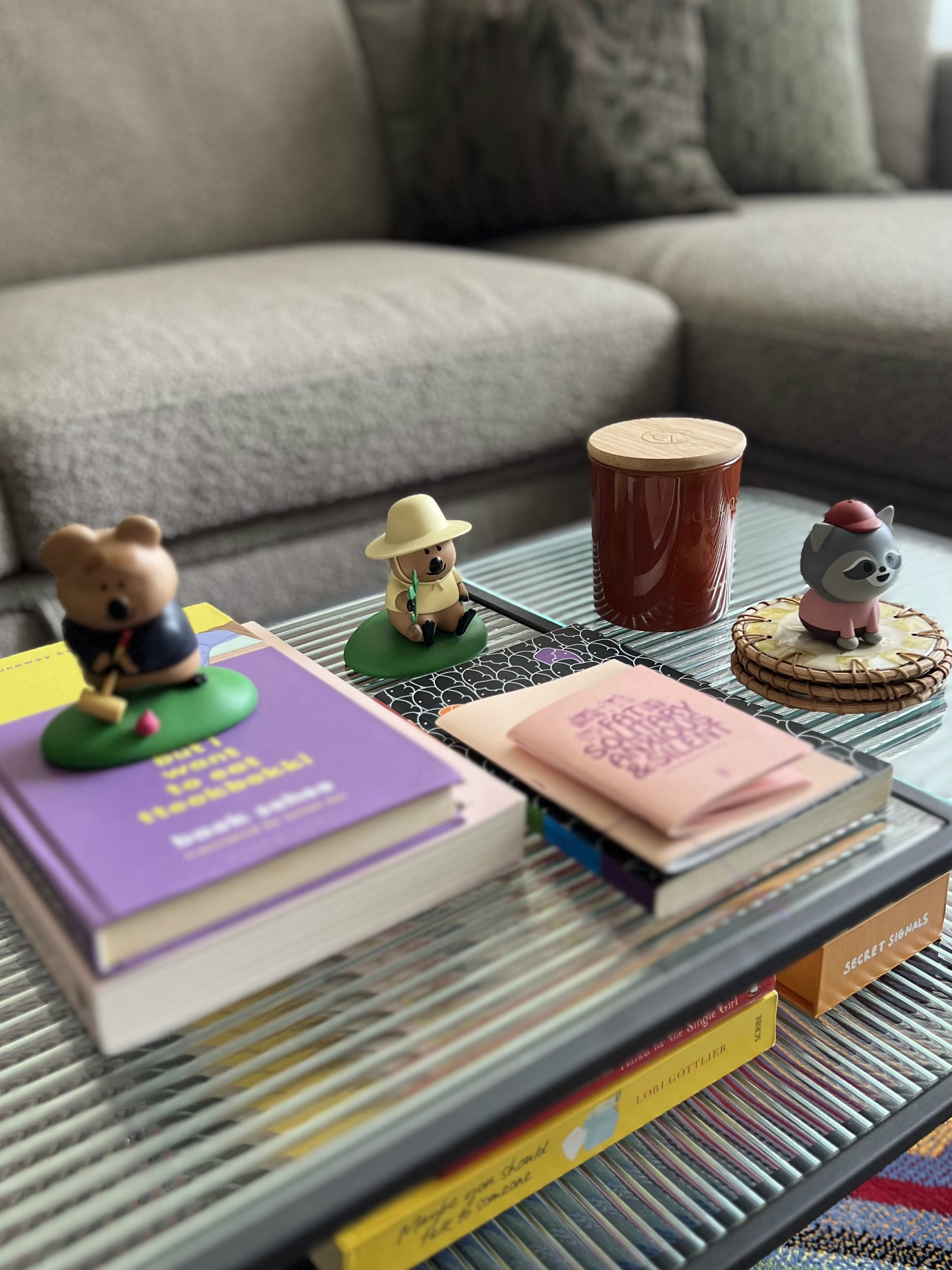 A Playground for Conversations  - Small figurines of bears, a cup, a book, notebooks, a basket, a sofa, a colorful rug, a