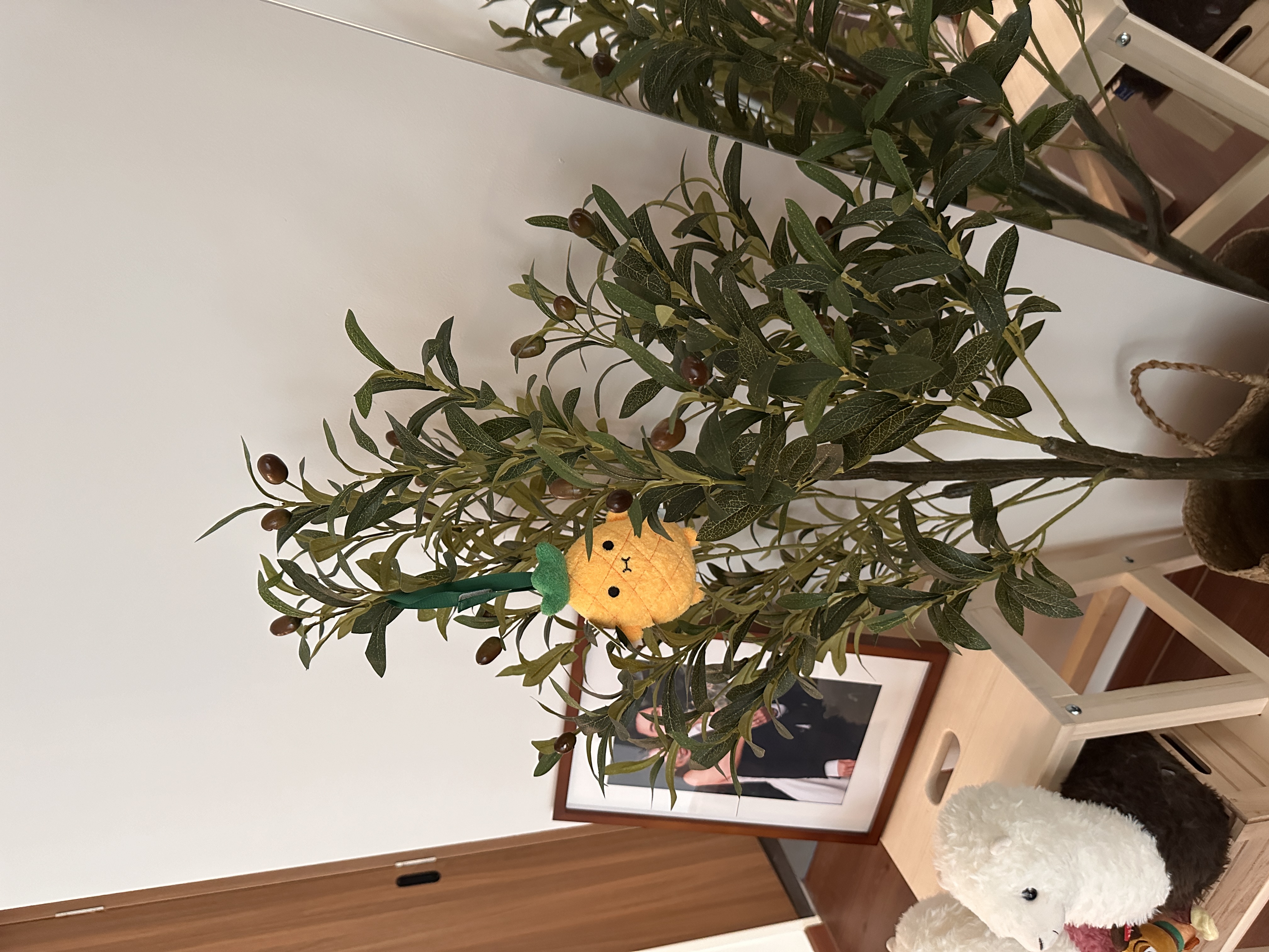 Faux plants are our new friends🪴  - plant with green leaves and small brown berries, yellow pineapple decoration hanging