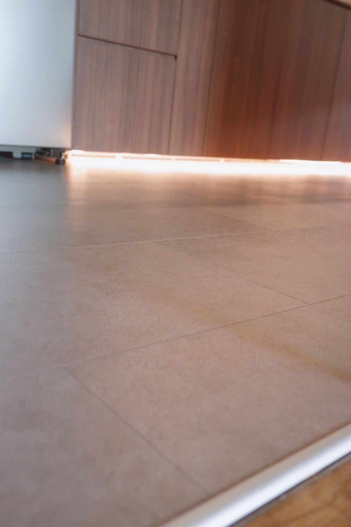 Our renovation journey as 2 "broke" newlyweds - Modern kitchen countertop, sleek cabinetry, warm lighting, minimalist design