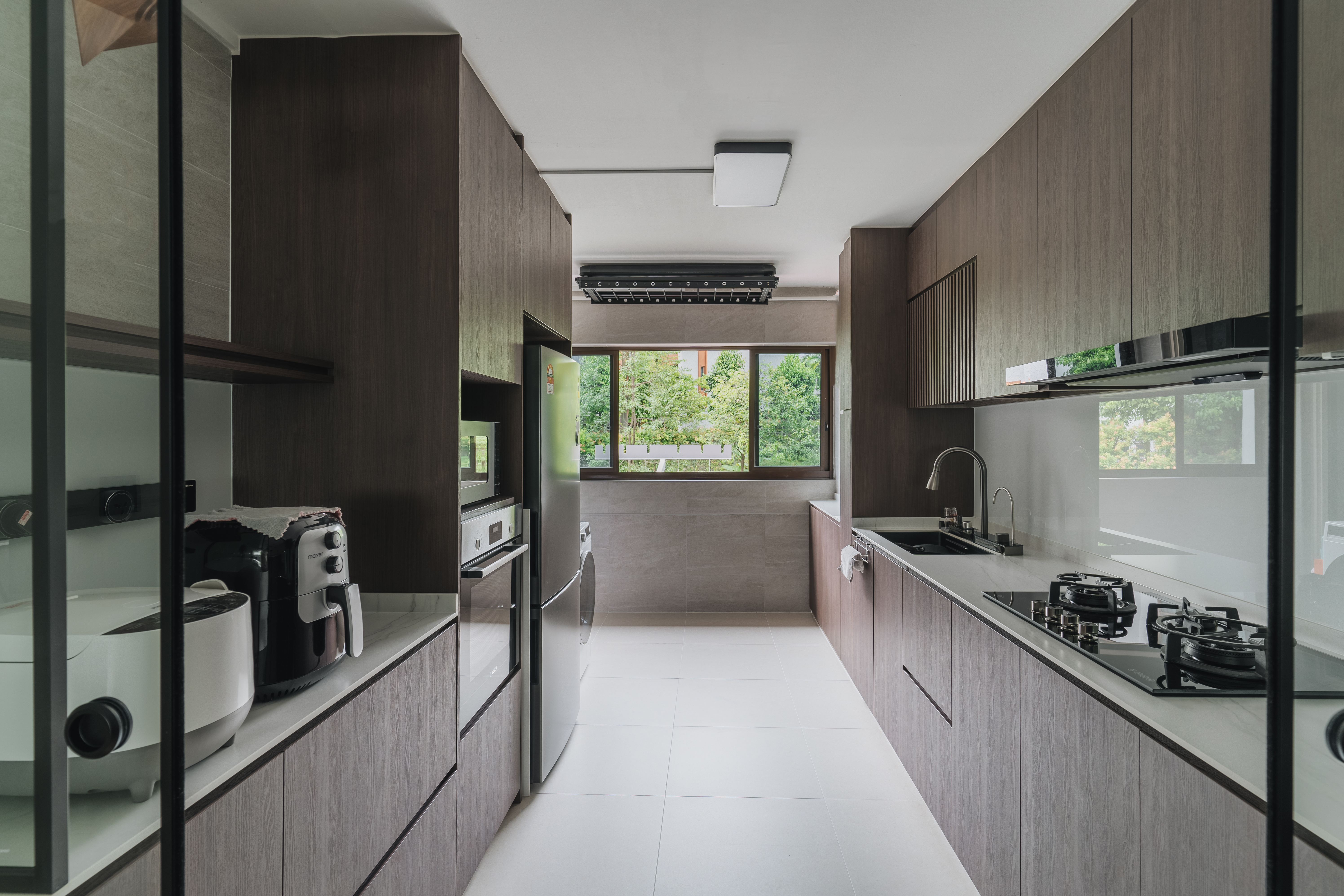 Welcome to our Serangoon Japandi-inspired 4-room haven! - Modern kitchen with sleek design, dark wood cabinets, stainless