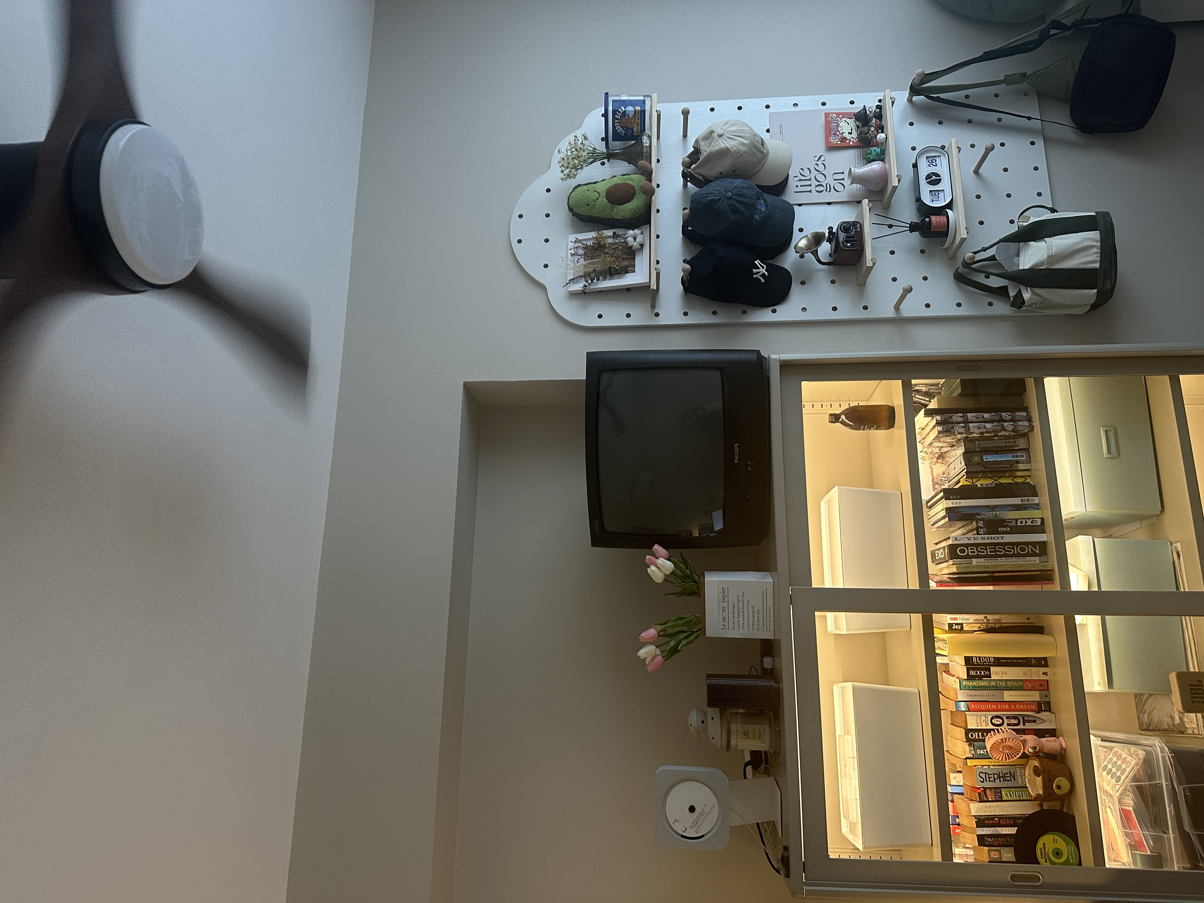 Our renovation journey as 2 "broke" newlyweds - wireless charging pad, TV, stack of books, stuffed animal, camera, mug